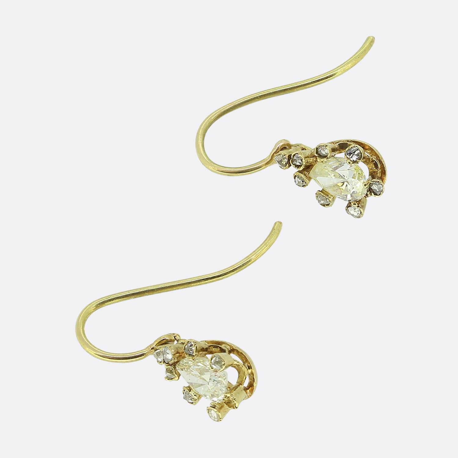 Here we have a lovely pair of old cut diamond drop earrings. The earrings are crafted in 18ct yellow gold and each feature an old pair cut diamond surrounded by eight rose cut diamonds. 

Condition: Used (Very Good)
Weight: 1.8 grams
Principal