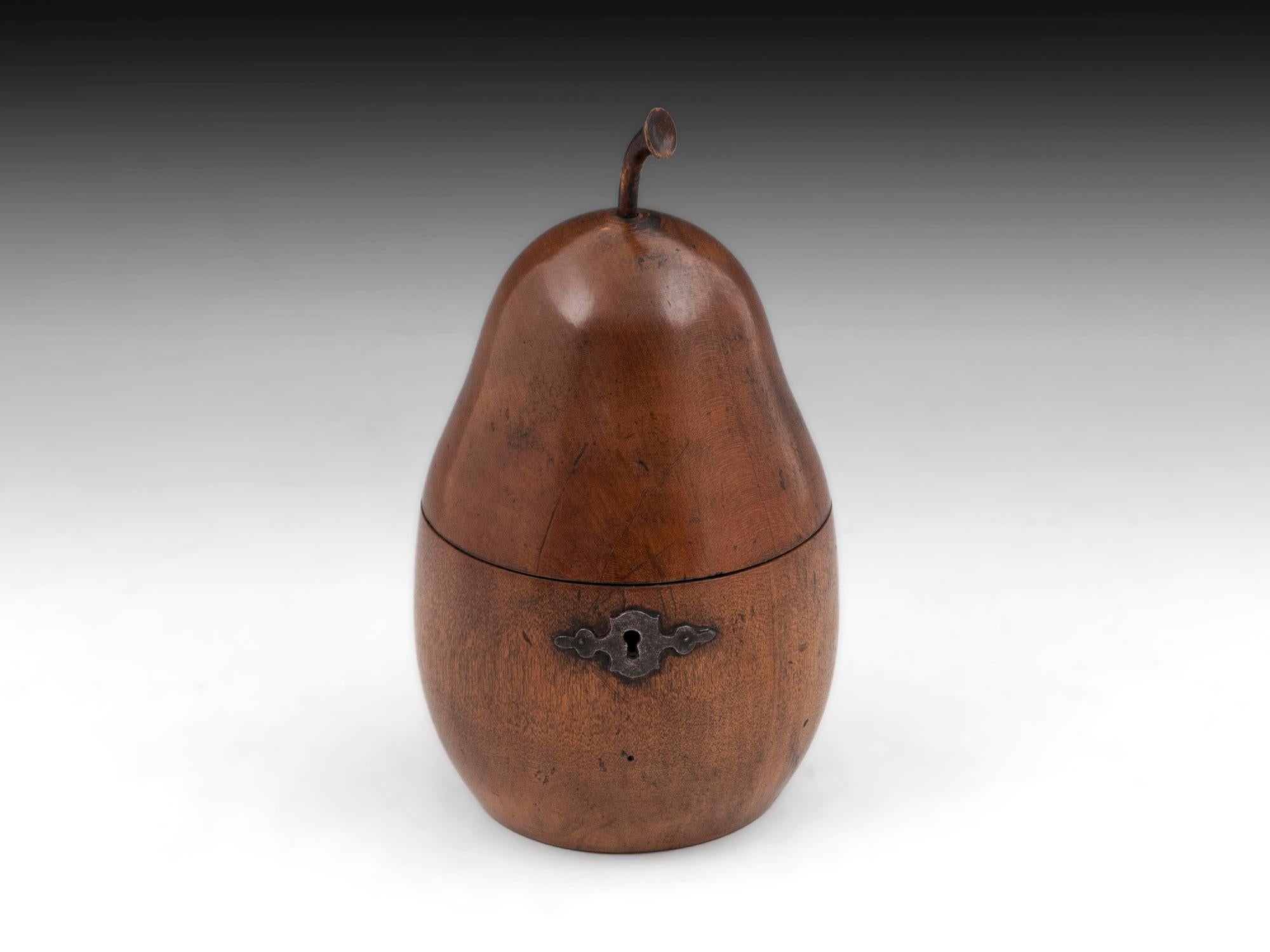 Antique tea caddy in the form of a Pear, with beautiful shape and patination topped with a realistic turned stalk. With steel hinge and ornate escutcheon.