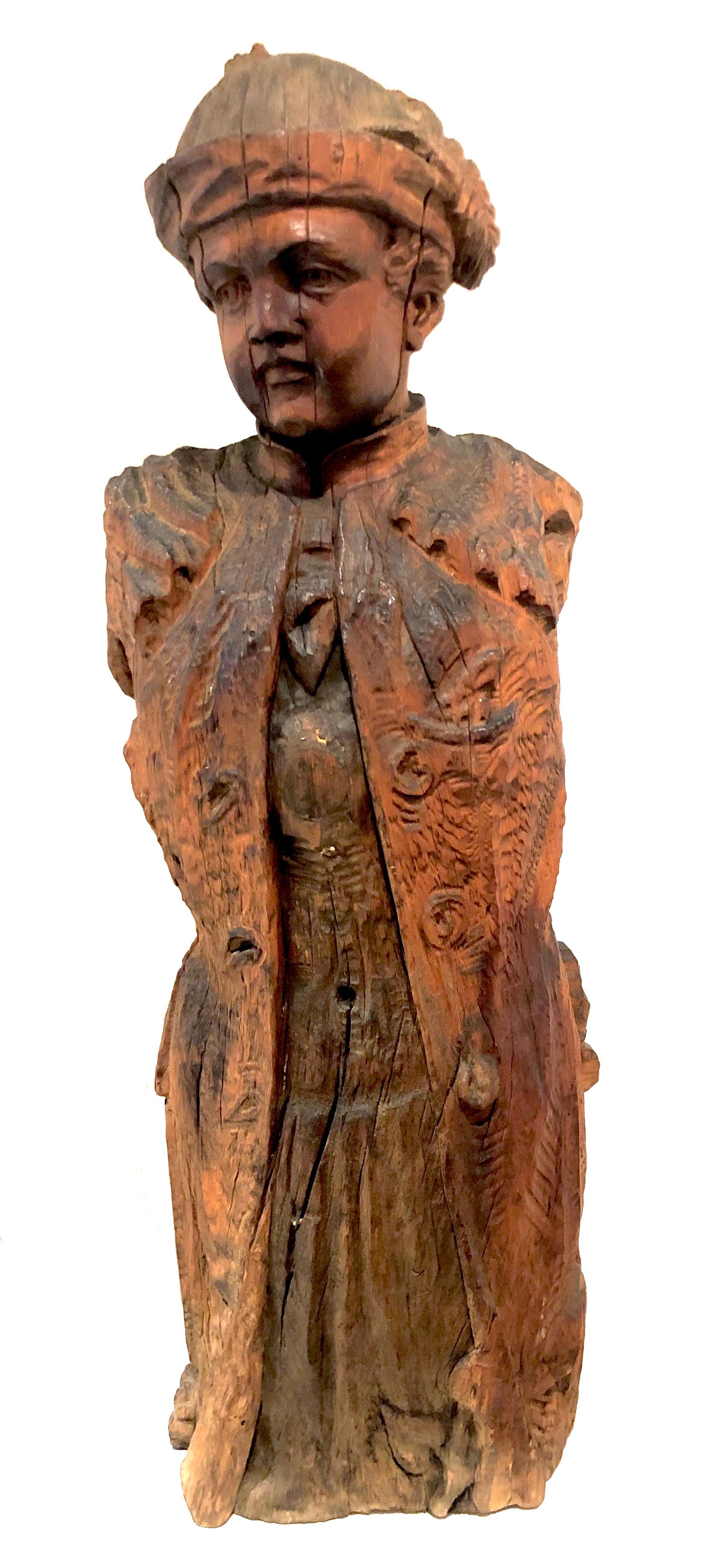 Beautiful carving of a young noble man dressed in a frock coat with a waistcoat and wearing a hat with a feather. 
The sculpture is carved out of an unusually large pear tree trunk. 
It was used in a garden as a fountain figure and is therefore
