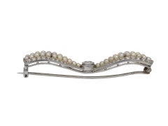 Antique pearl and diamond bow brooch, circa 1905.