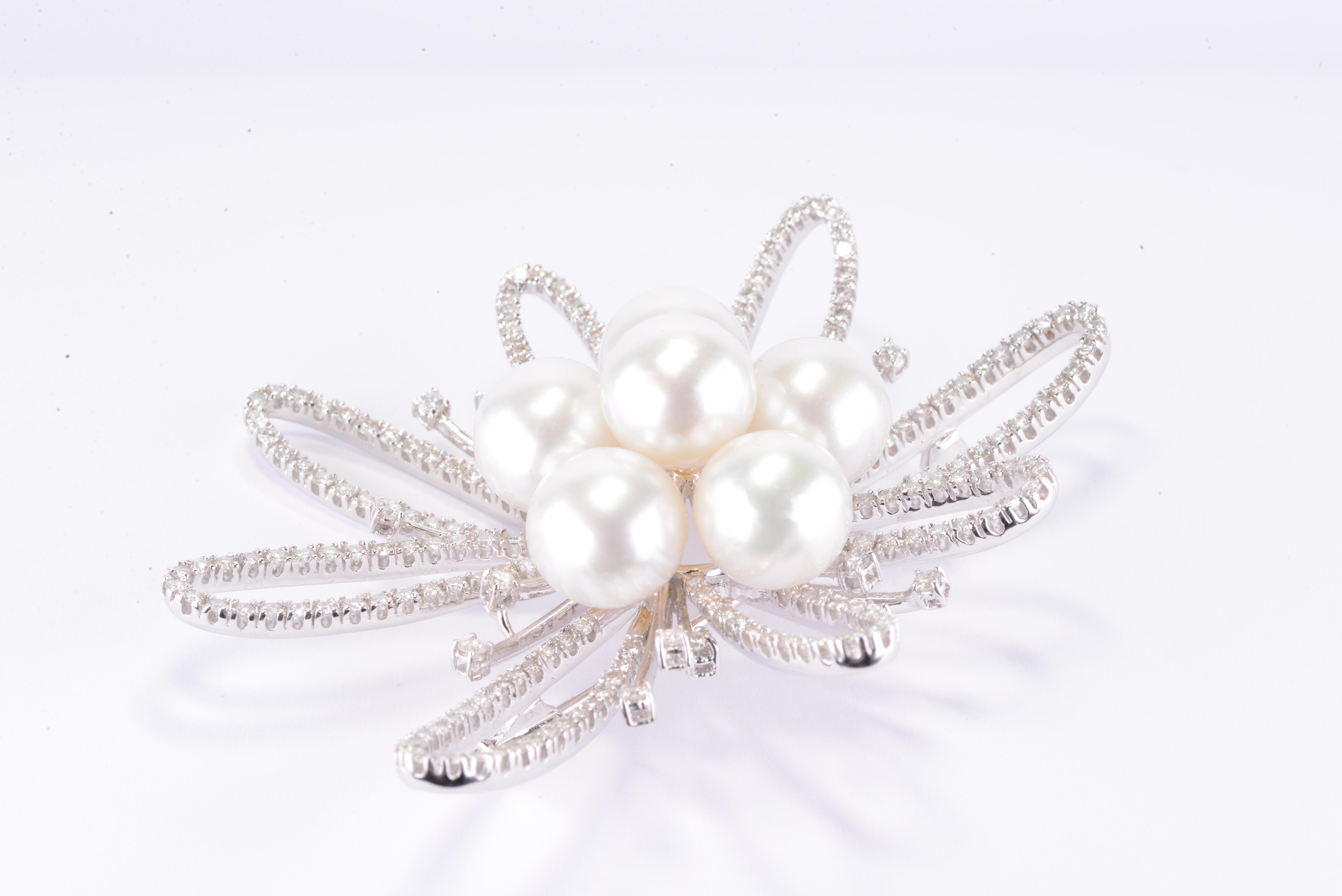 Beautiful antique natural pearl and diamond brooch. Natural diamonds are a total of 4.25 CT, F-G color VS2-VS1 clarity. Sitting in the middle of this brooch are 7 shiny pearls, 10 mm each. This beauty is set in 18K white gold. Proudly crafted in NYC