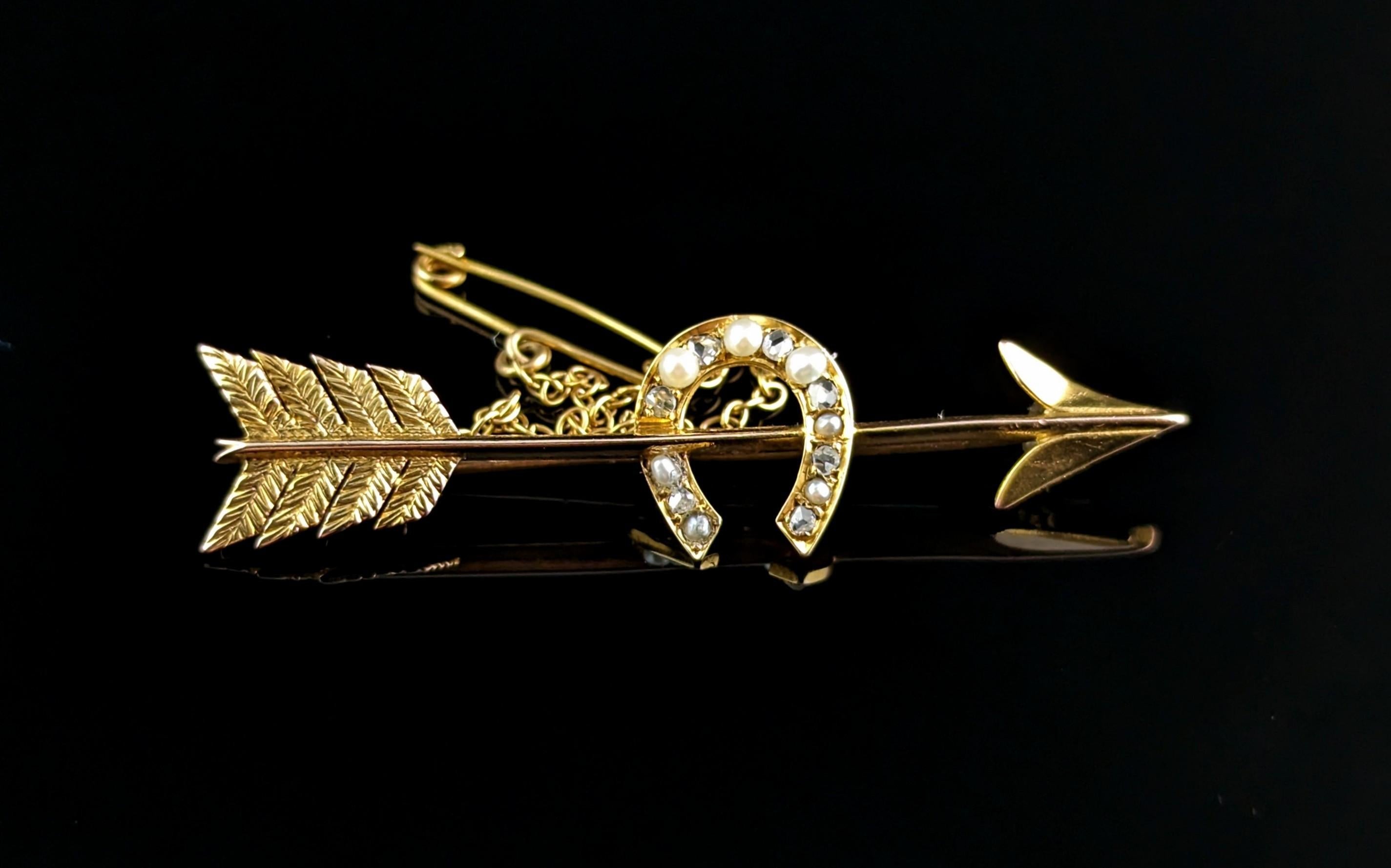This beautiful antique 15kt gold Arrow and horseshoe brooch is a real charmer! Rich in both symbolism and style you can't go wrong.

A slender feathered arrow with the rich buttery gold hue only found on antique gold, it has a slightly brushed