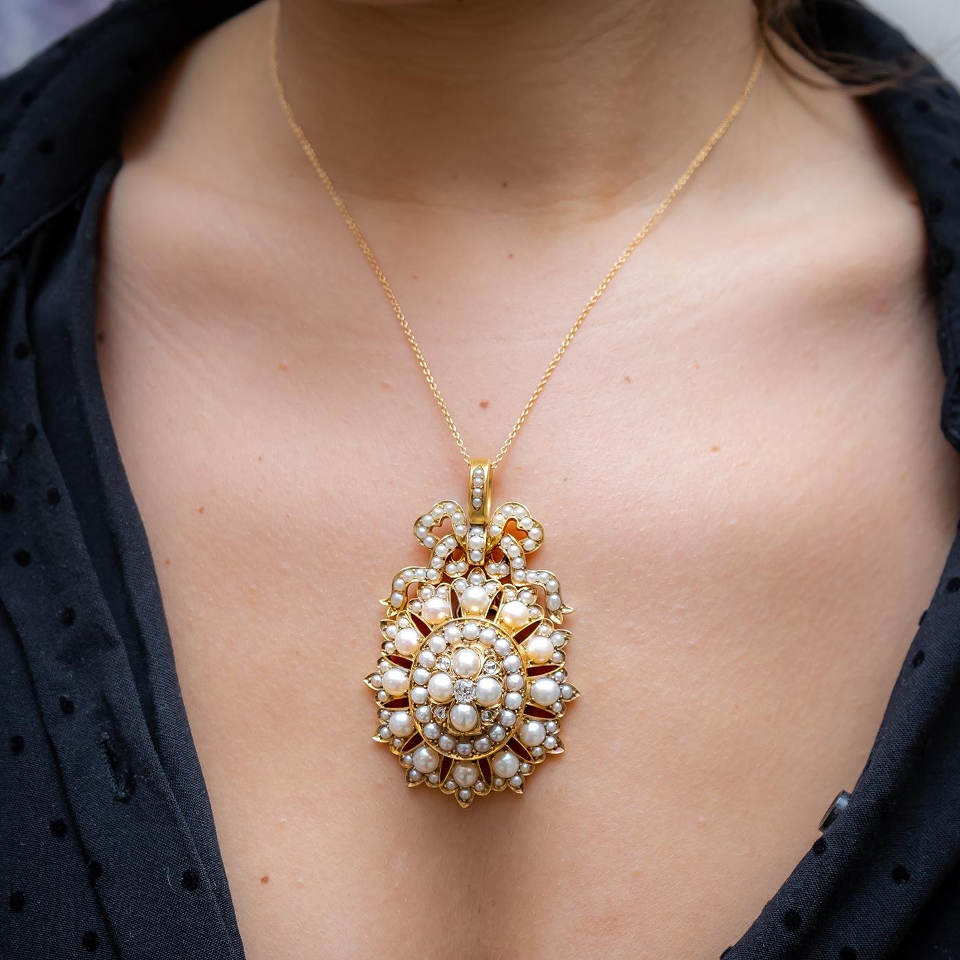 An antique half pearl and diamond pendant, with an old-cut diamond set in the centre, surrounded by four natural half pearls and four rose-cut diamonds, with a surrounding row of eighteen natural half pearls and a border of pearl set petals, with a