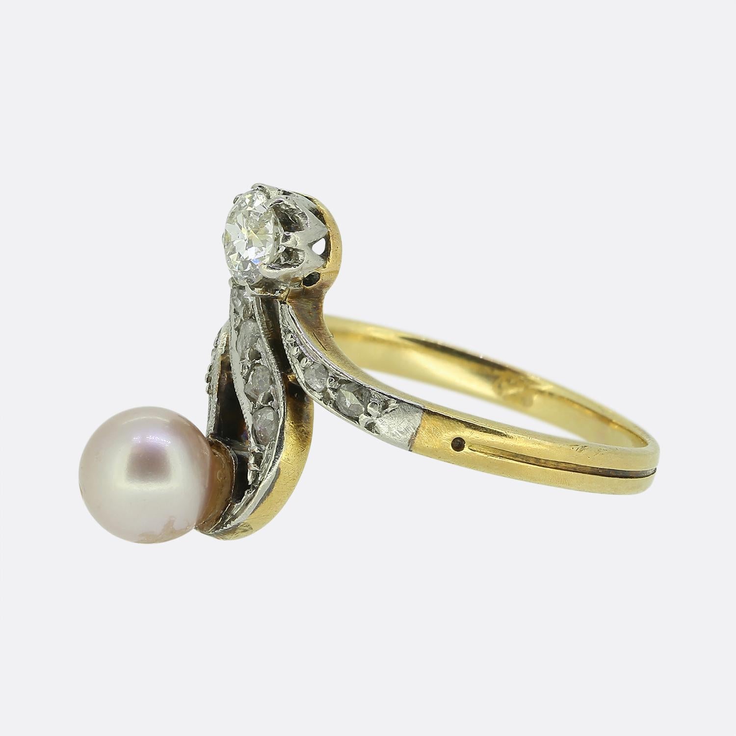 Here we have a delightful antique swirl ring. The piece showcases two focal stones including a lustrous rounded pearl and a round faceted old European cut diamond which are elegantly complemented by a series of swirling motifs set with rose cut