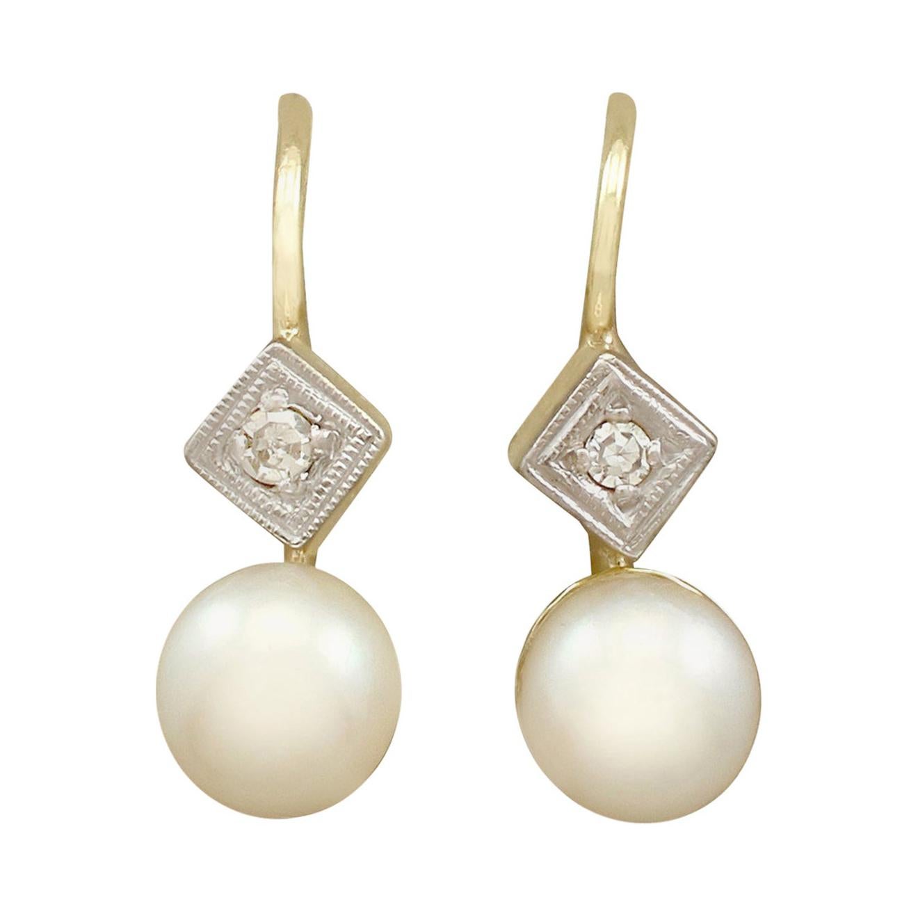 An impressive pair of antique pearl and 0.06 carat diamond, 14 karat yellow gold and 14 karat white gold set drop earrings; part of our diverse antique jewellery and estate jewelry collections.

These fine and impressive 1930s pearl earrings have