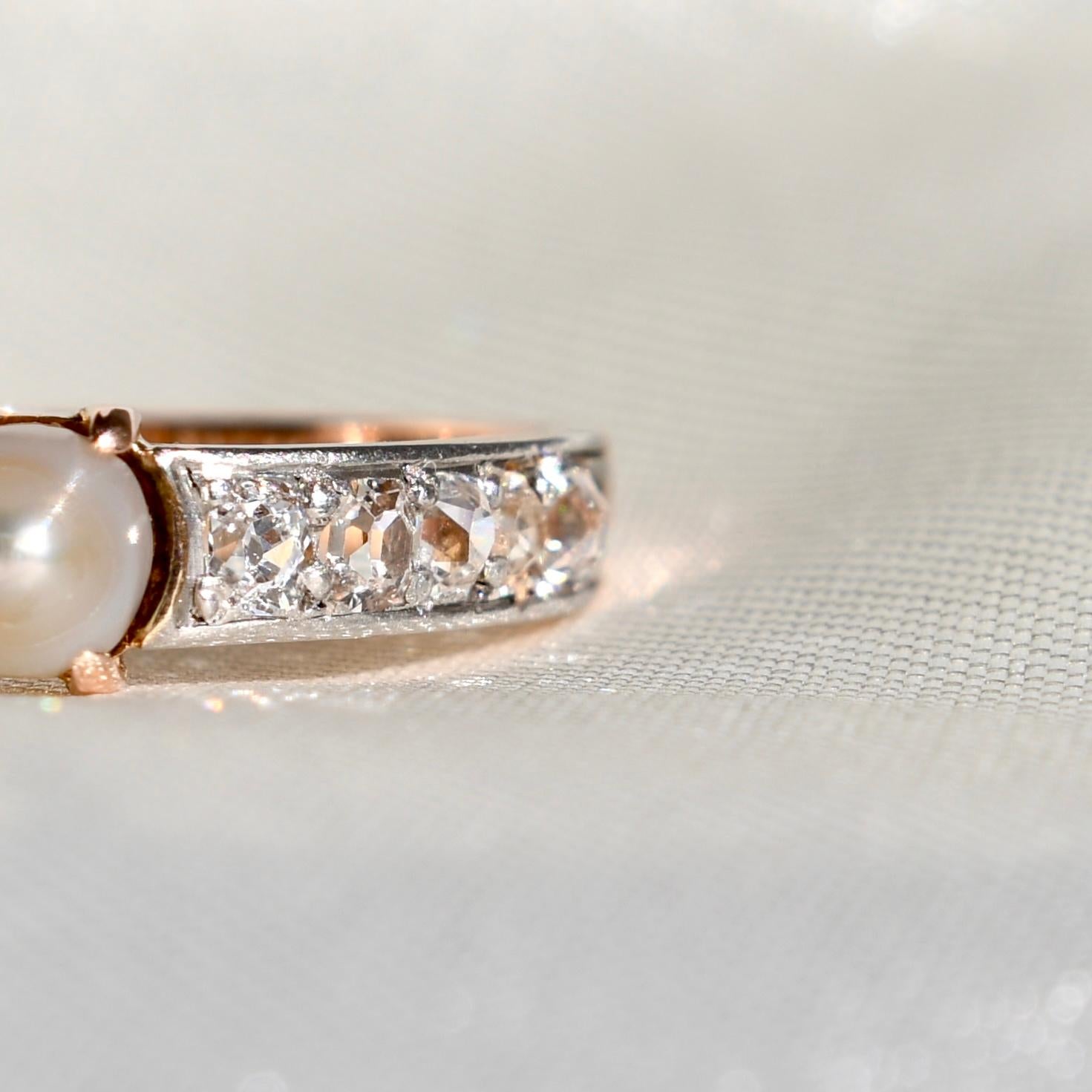 This ring was made in France circa 1900 and is in good, antique condition. 

- One pearl, 4.5x4.5 mm 
- Ten old mine cut diamonds, approx. 0.90 ct total 
- 750/ 18 ct yellow gold and platinum
- Ring size: EU 54, UK N, US 6 1/2 (Resizeable within