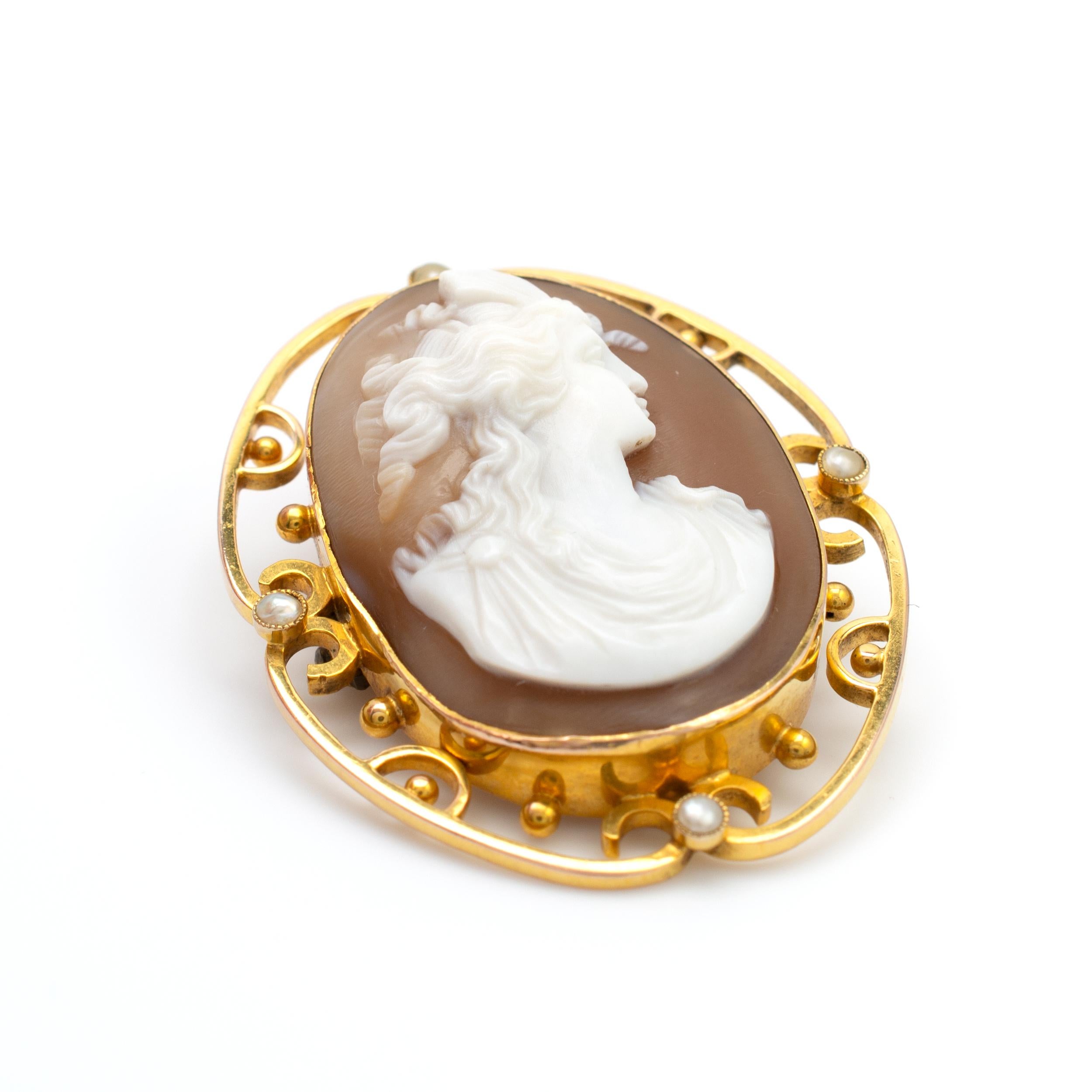 This antique 9 karat gold cameo brooch features a decorative gold frame set with pearls. 

The shell carving is beautifully executed showing, in relief, a defined female portrait with layered detail.

The cameo is neatly set and beautifully framed