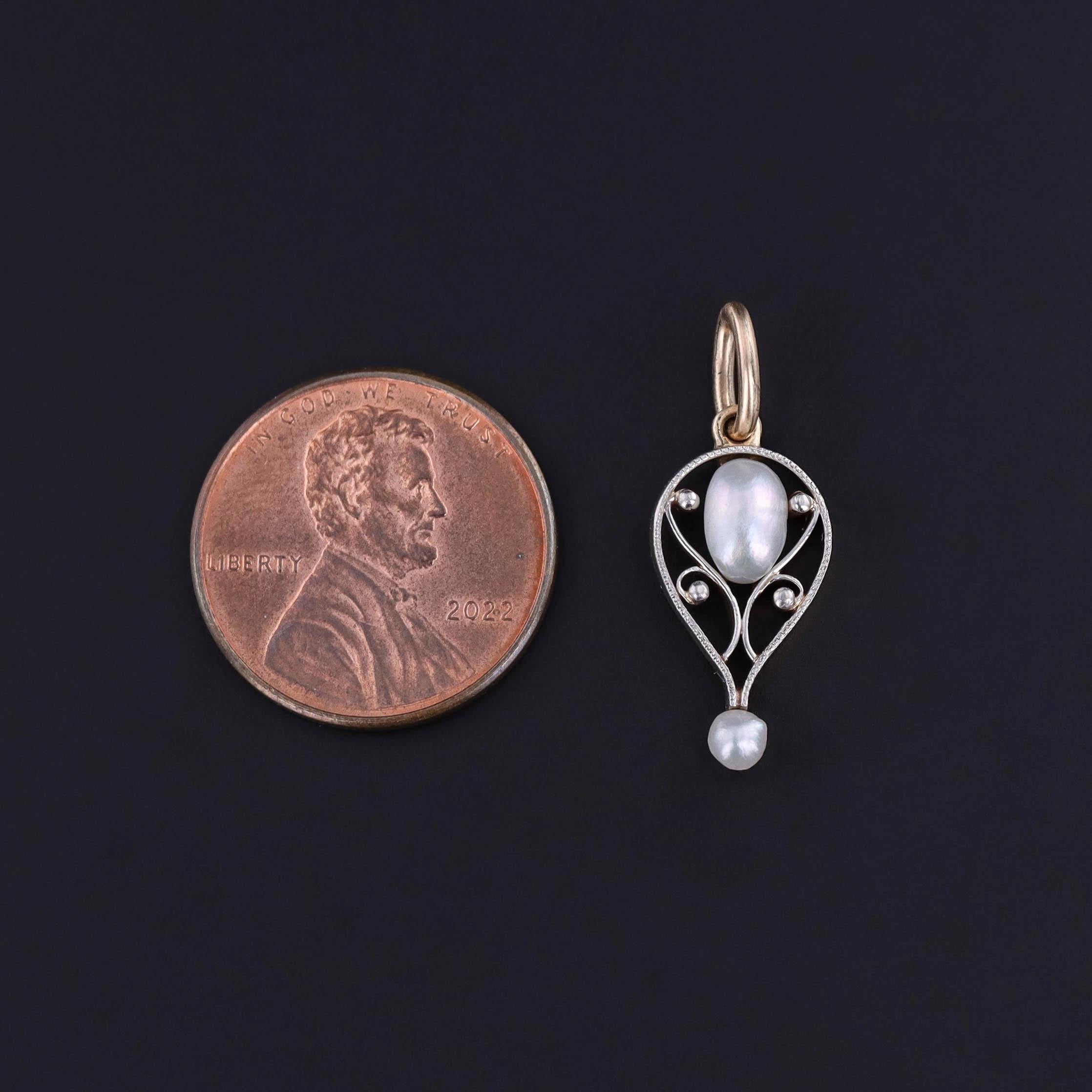 Delicately reimagined from an antique stickpin (circa 1900), this elegant charm features two luminous pearls nestled in platinum-topped 14K gold, blending Edwardian refinement with modern versatility. The contrast between the soft sheen of the