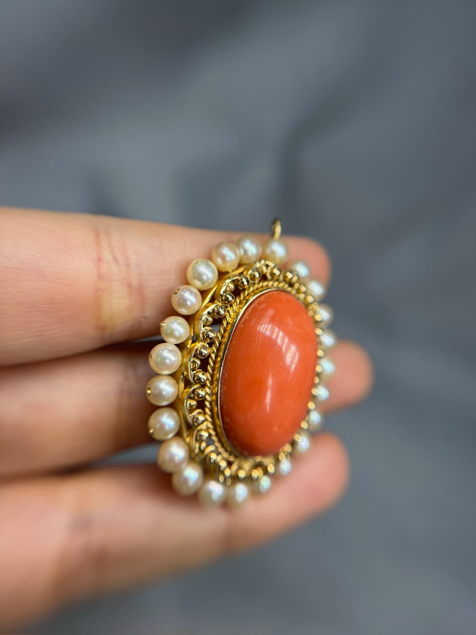 Elegant and timeless, this antique pendant features a beautifully carved oval coral centerpiece accented with lustrous pearls. Crafted in rich 18k yellow gold and weighing 18.18g, this pendant showcases classic vintage charm with a warm,