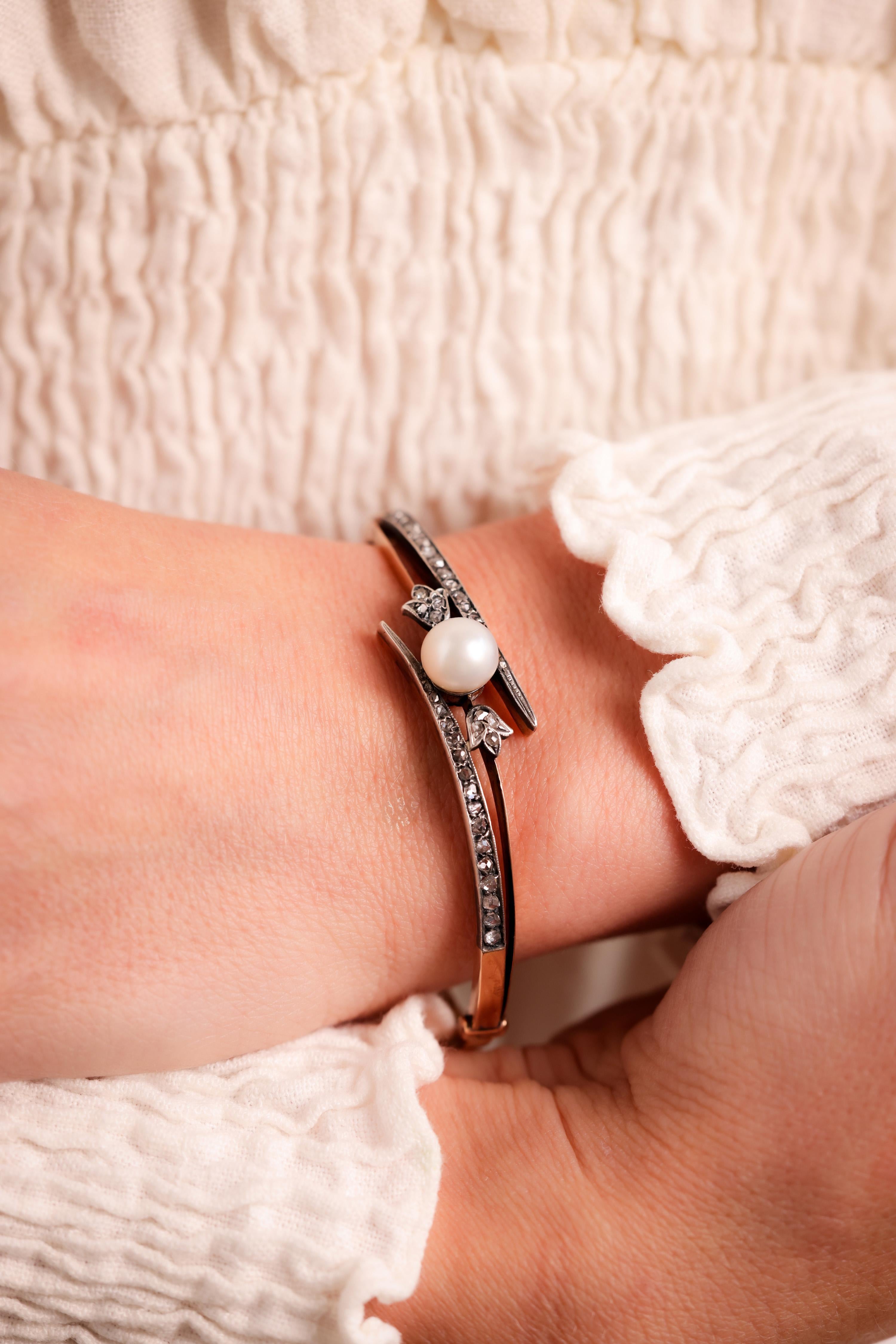 Center Stone:  Pearl
Size: 8.46mm
Accent Stone: 42 Diamonds
Cut: Rose Cut
Weight: Approximately 0.7 Carats
Color: J
Clarity: SI
Metal: 18K Rose Gold and Silver
Era: Antique
Circa: 1890s
Hallmarks: 18K Purity Marks and Makers Marks
Size: 2 1/4 inches