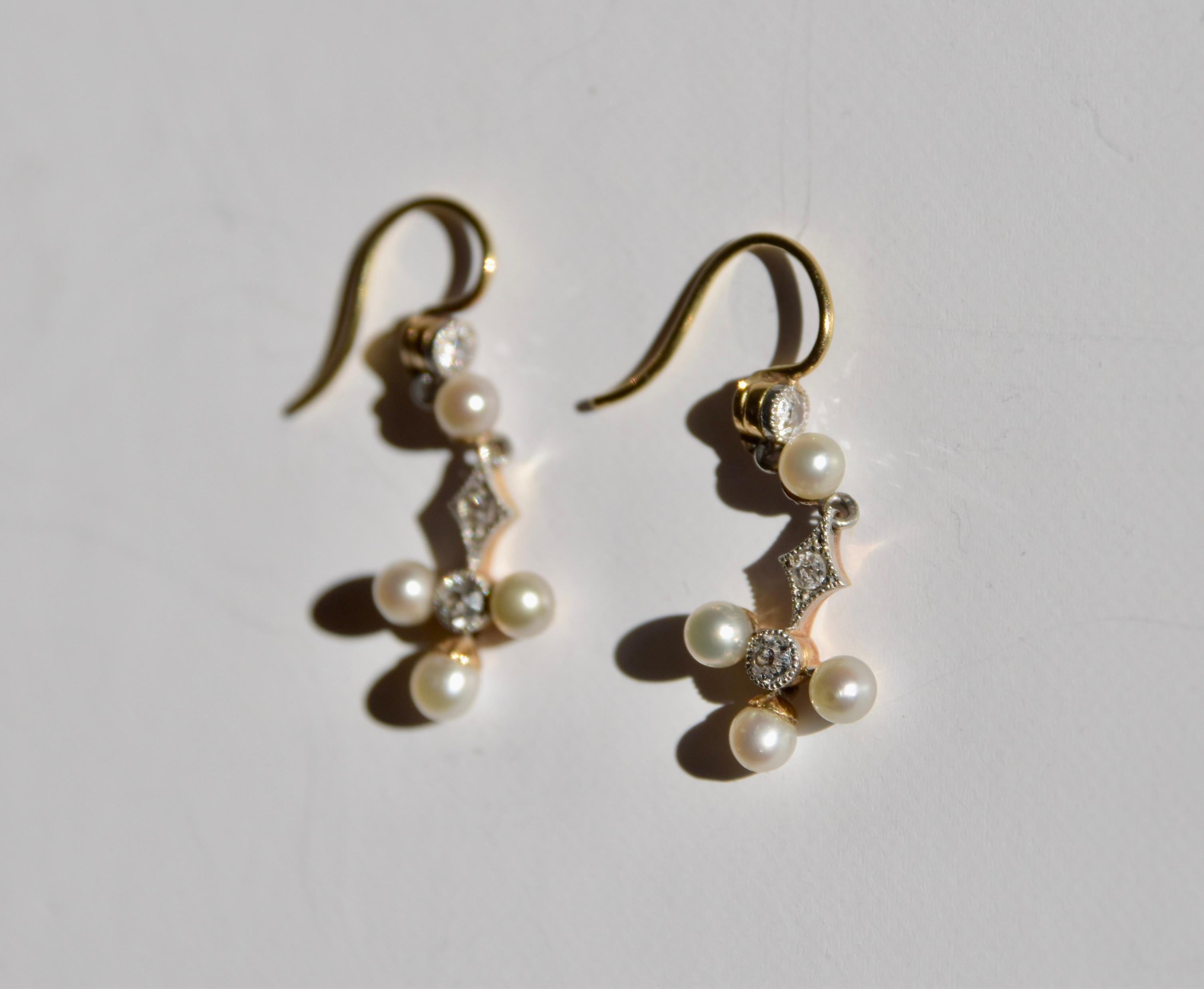 Antique Diamond and Pearl dangle earrings made up of three moving sections. Finished with gold french hook fittings. The three diamonds are millegrain-set, complimented by four pearls all set in gold and possibly silver. 

Weight: 1.2g each, 2.4g in