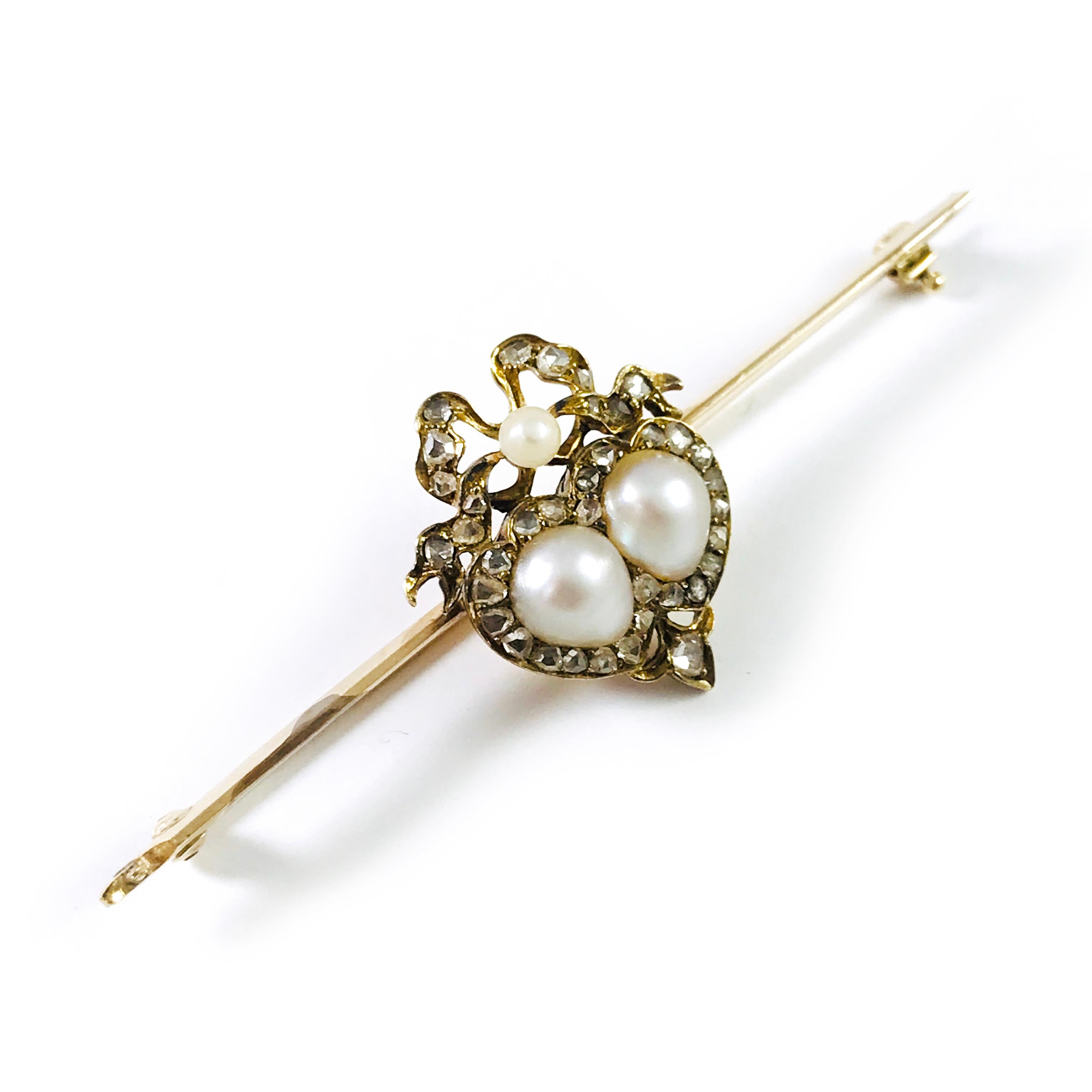 Antique Victorian Pearl Rough Diamond 14 Karat Yellow Gold Pin/Brooch. Two Baroque pearls in the center form a heart-shape with a ribbon above and a single 3mm round pearl in the center of the ribbon. Thirty-seven mine-cut diamonds serve as the