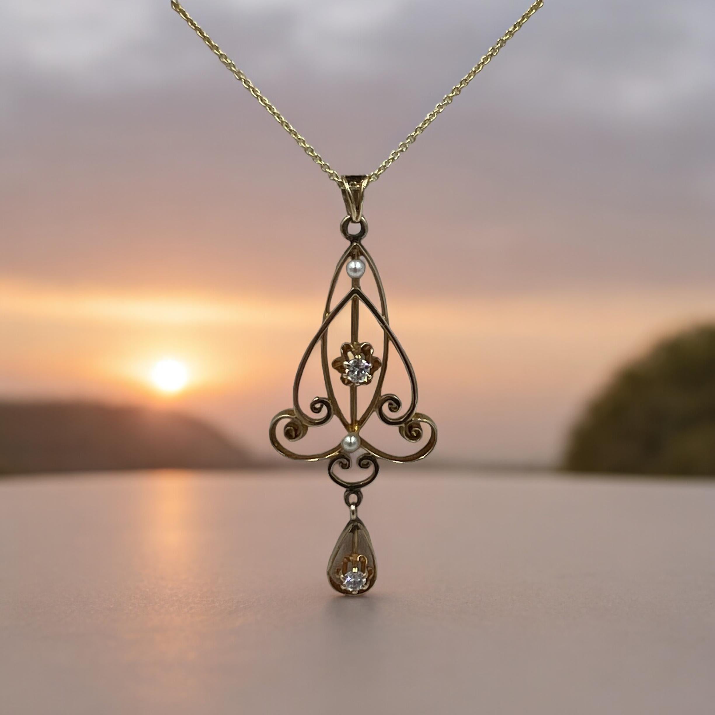Antique pearl diamond yellow gold lavalier pendant, circa 1900.

 The antique pearl diamond yellow gold lavalier from the 1900s was all handmade with its attention to detail and intricate pattern of the open filigree work. The use of small diamonds