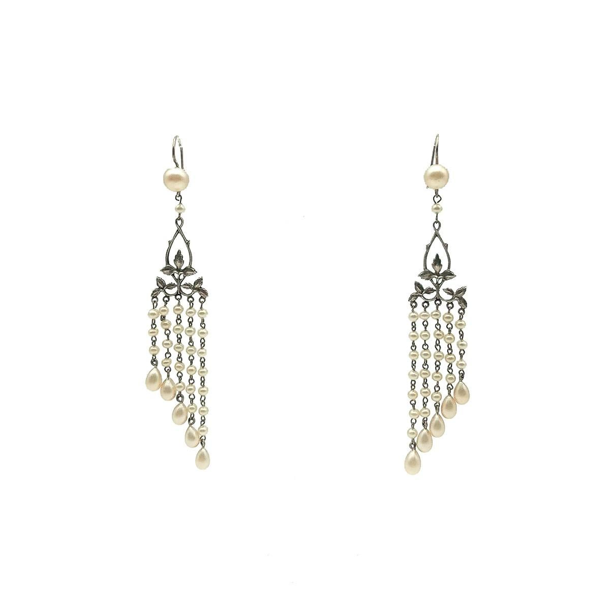 A rare pair of seriously elegant Antique Pearl Droplet Earrings created around 1920 which was undoubtedly the era of the long earring; a key accessory for the modern woman breaking from tradition to create her flapper style look. Crafted in silver