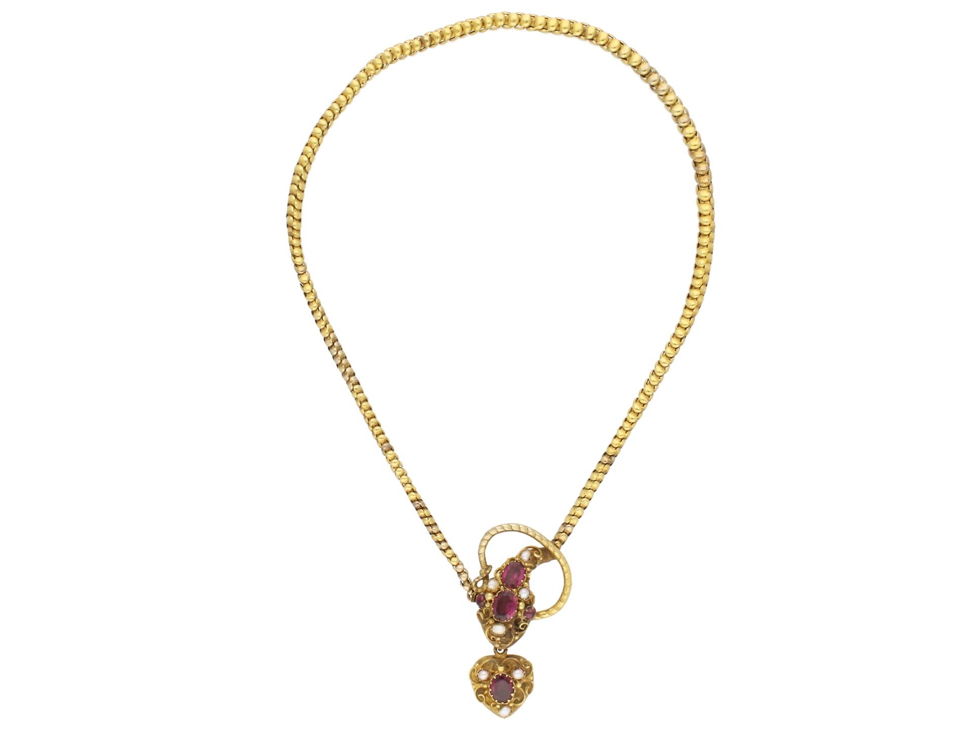 Antique garnet and pearl set snake necklace. Set with three oval old cut garnets in closed back claw settings with a combined weight of 4.00 carats, flanked by two round cabochon garnets to centre with a combined weight of 0.40 carats in claw