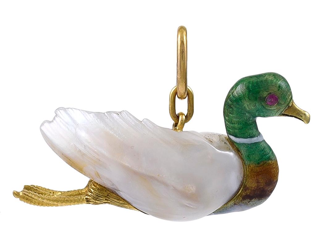 The body made from a large Natural Baroque Pearl and with Enamelled neck and head, Gold beak and Ruby eyes, with skilfully engraved Gold feet in the paddling mode. The Gold suspension bale has French 18k marks and the Duck is identical on either