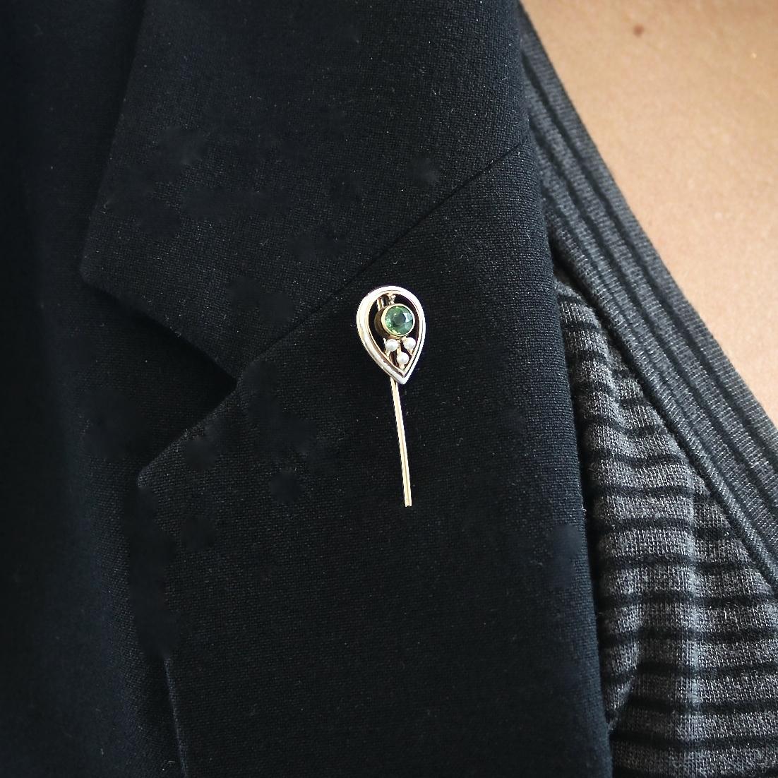 14k yellow gold Edwardian Pin with a round faceted green tourmaline that weighs approximately 0.30 carats, seed pearls, and decorated with white enamel. Circa 1900.
Our 1stdibs Recognized Dealer/Platinum Seller Guarantees: 
7 day return policy for