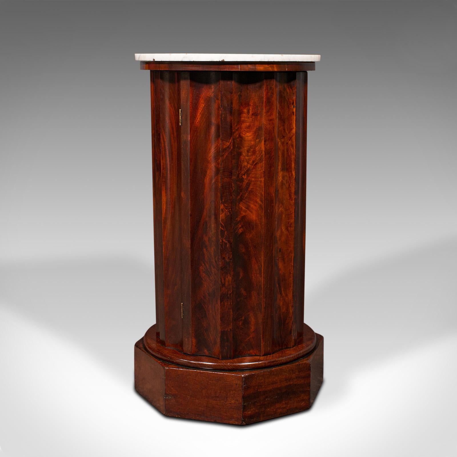 This is an antique pedestal cabinet. An English, flame mahogany and marble nightstand cupboard, dating to the early Victorian period, circa 1850.

Of unusual and fascinating form, a treat for the bedside or lounge
Displays a desirable aged patina