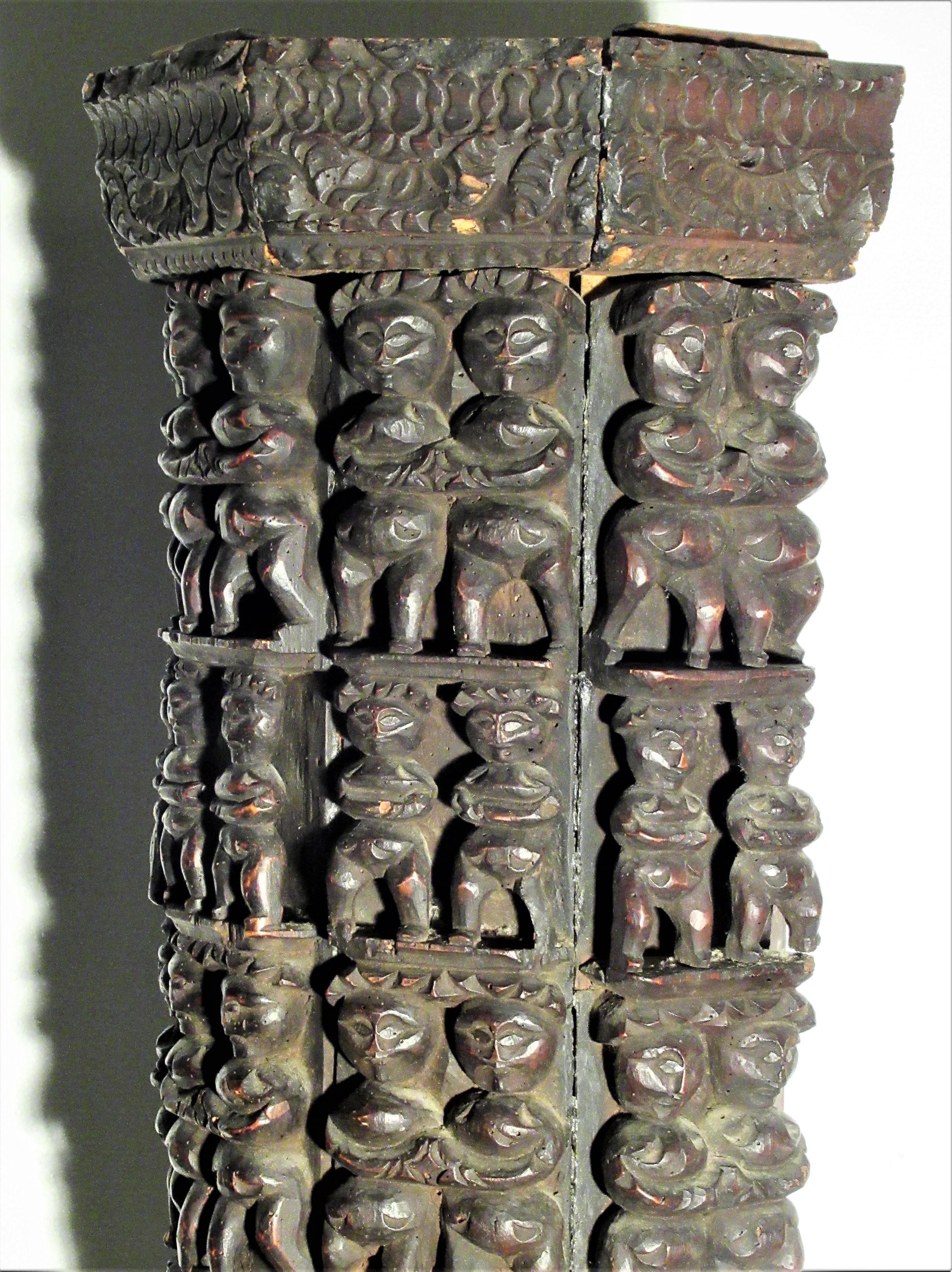 Antique pedestal constructed of carved wood architectural panels mounted with various sized repeating primitive bold ceremonial or fertility type figures. Origin believed to be Nagaland, India. The figural carvings with beautifully aged deep rich