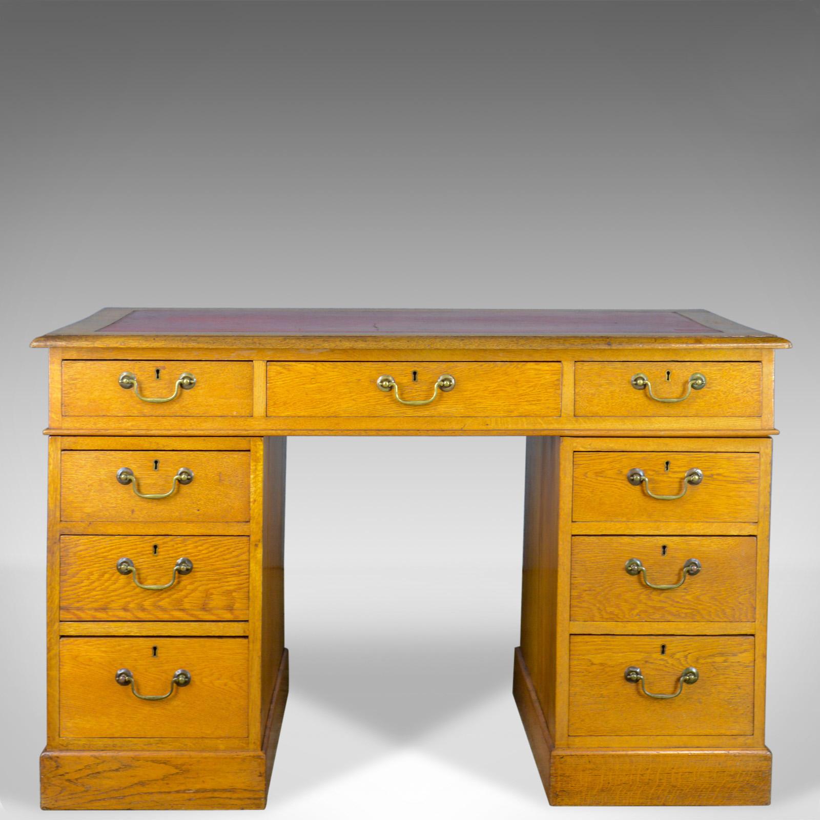 This is an antique pedestal desk, an English, Victorian, golden oak, single desk with leather skiver dating to the late 19th century, circa 1890.

Mid-sized with a 'show back' ideal for centre room placement
The oak in honey hues with good