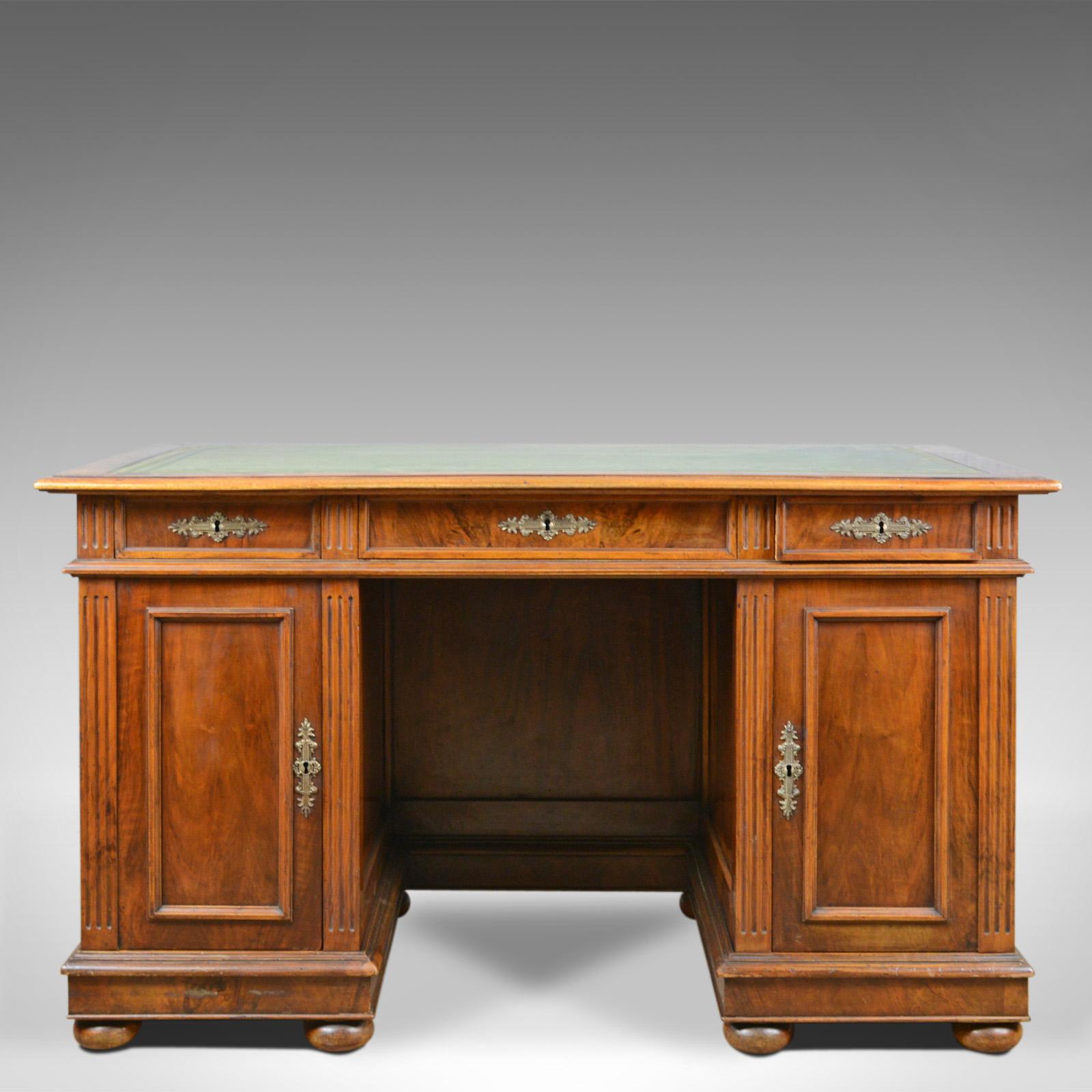 This is an antique pedestal desk, a French, 19th century, walnut with a leather top, dating to circa 1880.

Attractive, select walnut
Good consistent color in the wax polished finish
Grain interest throughout with a desirable aged patina
Raised