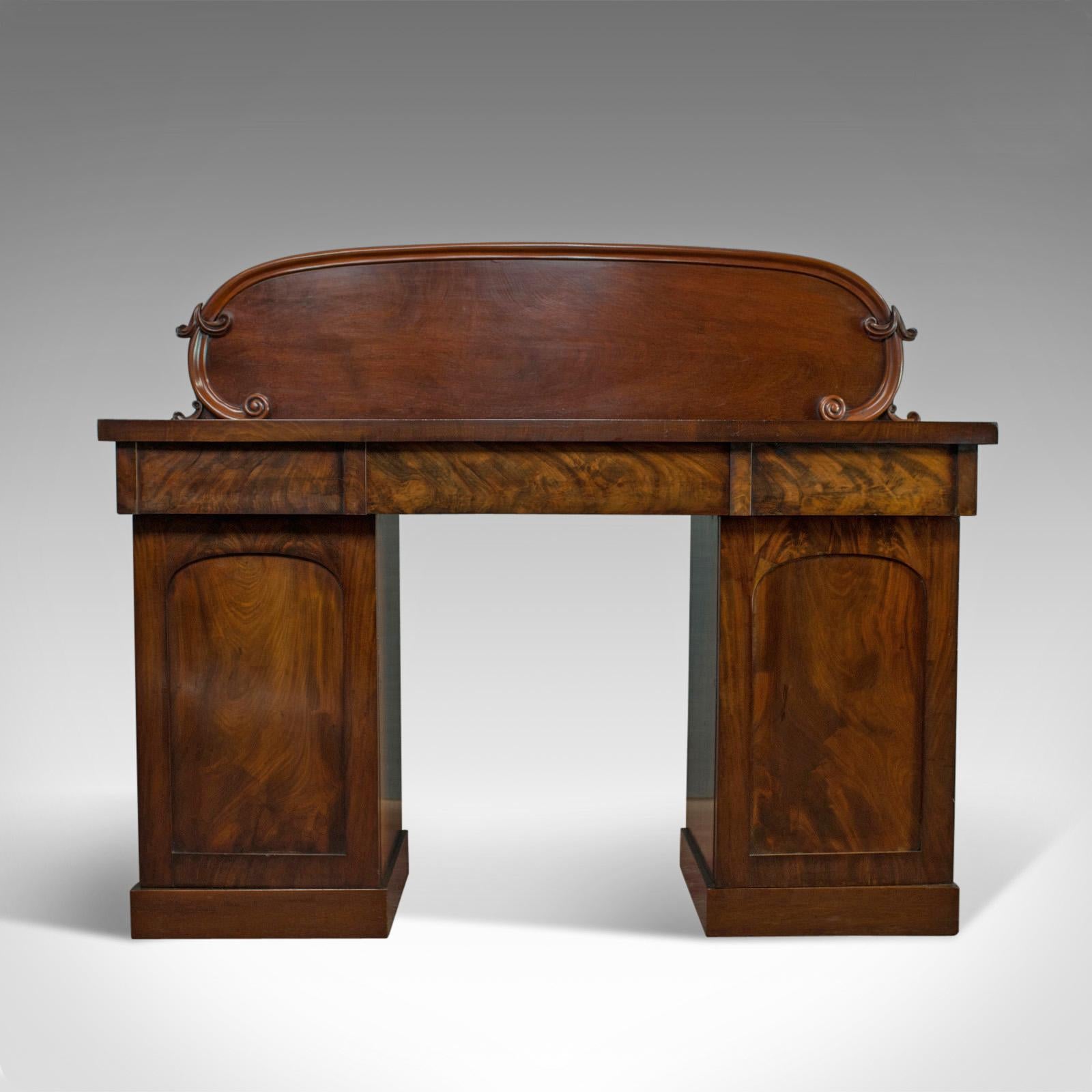 This is an antique pedestal sideboard. An English, early Victorian, mahogany dresser dating to the mid-19th century, circa 1850.

Select mahogany resplendent with flame figuring and fine grain interest
Good consistent color throughout and