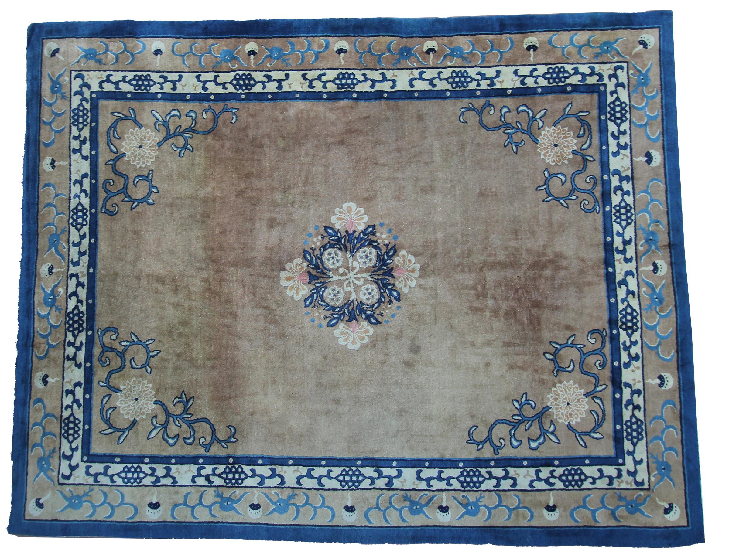 This exquisite circa 1870 Chinese Peking rug features a soft brown field framed by deep blue borders and delicate floral corner motifs, centered by a detailed blossom medallion. Hand-knotted in wool with refined Art Deco sensibilities, it showcases
