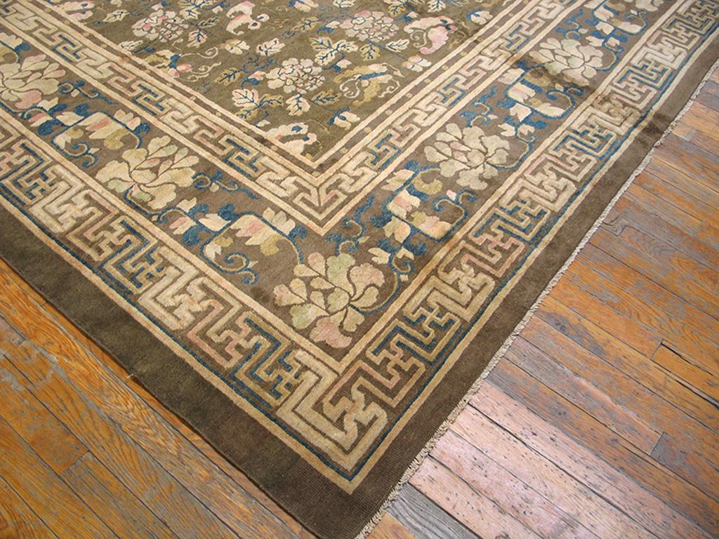 Tous les tapis de Pékin ne sont pas bleus. Car voici une antiquité brune avec une répétition sur toute la surface de pivoines, papillons et feuilles, en rangées horizontales, clairement adaptée d'un textile de brocart de soie. De grandes paeonies