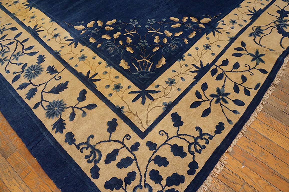 All the decoration is delicate and floral in this royal blue circa 1890 Peking carpet with a round foliate medallion and matching triangular corners. Finely detailed ivory borders in two scales enframe the whole. There is nothing out of scale, no