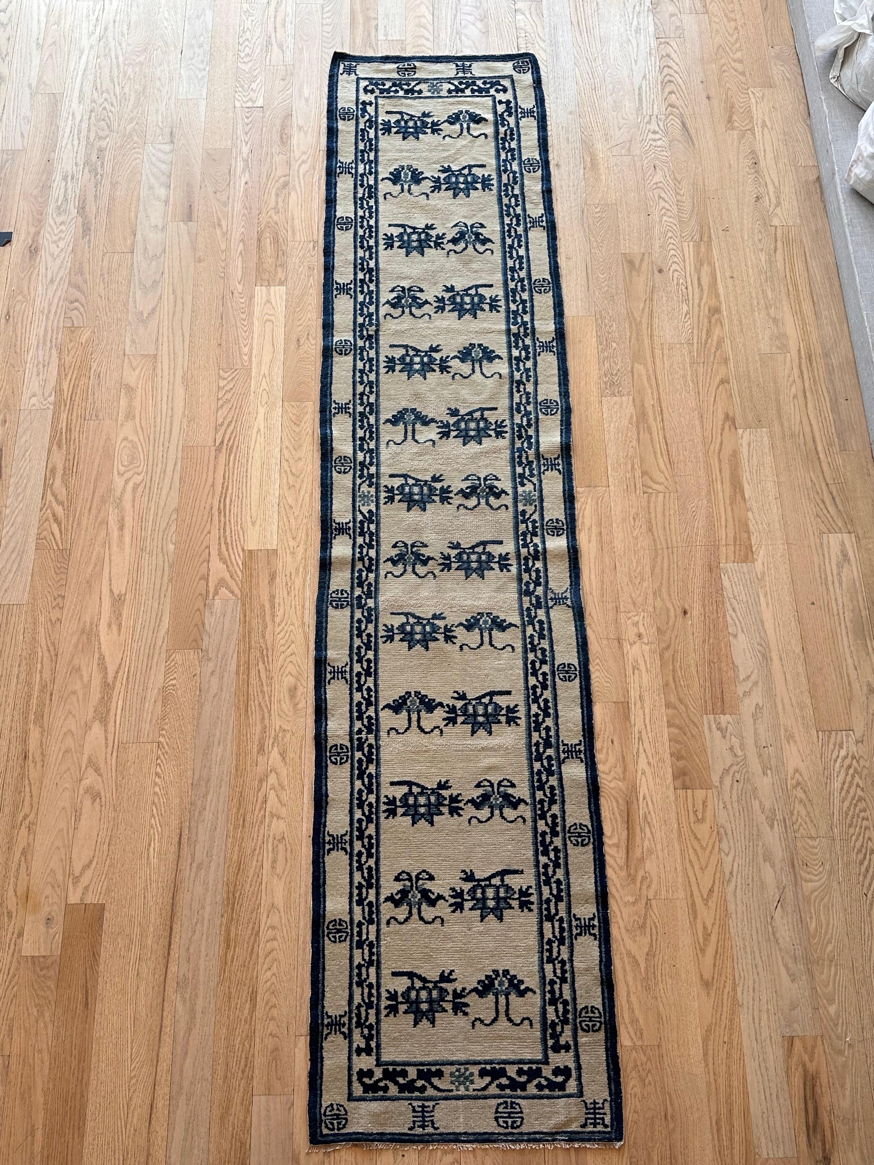 This exquisite Antique Chinese runner, woven in the distinguished Peking style circa 1870, features a rare and sought-after white and blue color palette. The piece measures approximately 2'2