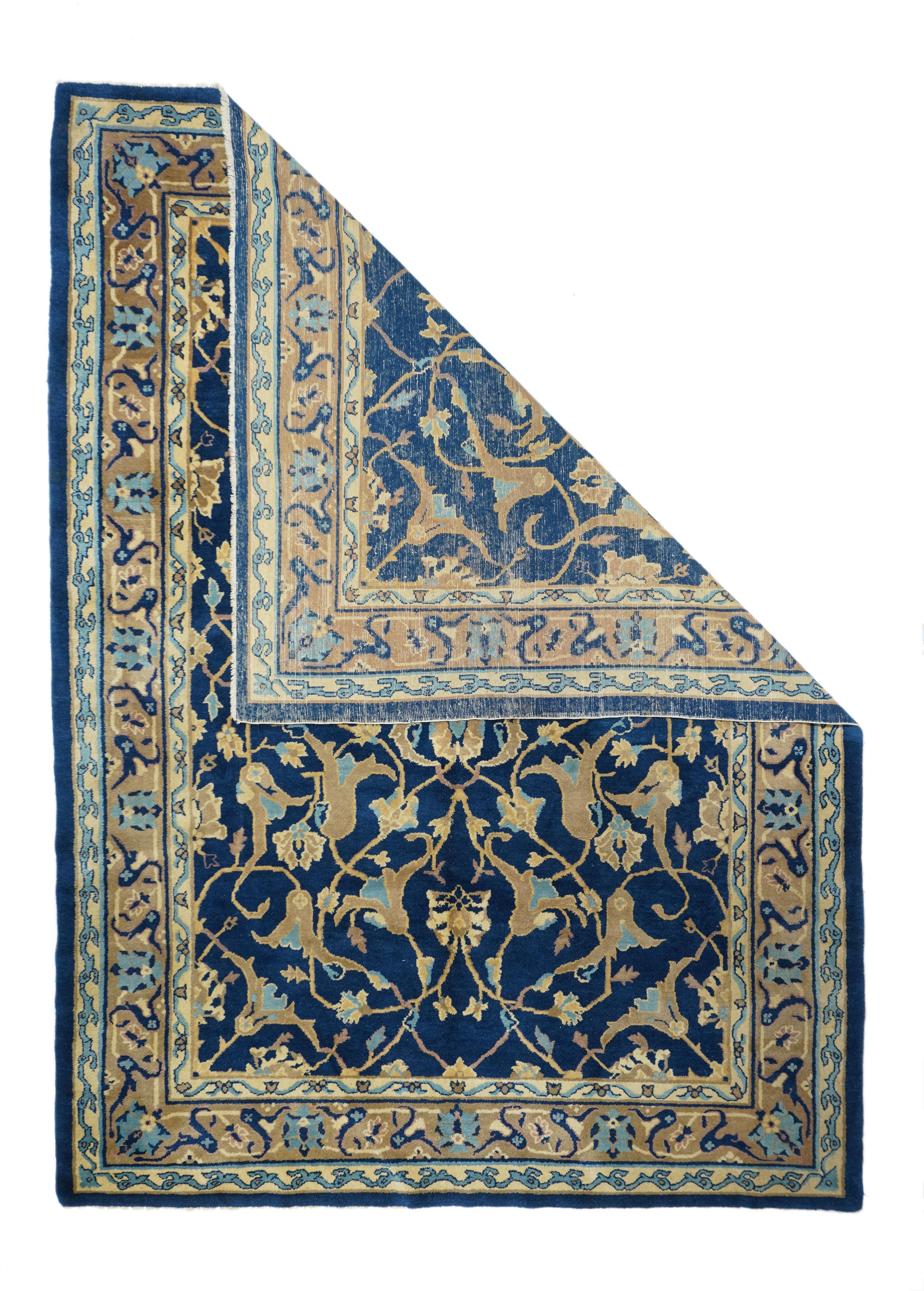 From the short Post-WWI period when Chinese weavers copied Persian pieces which were then in short supply. The dark blue field displays a two level arabesque and forked leaf pattern around a central four palmette motif. Rose-coral border with