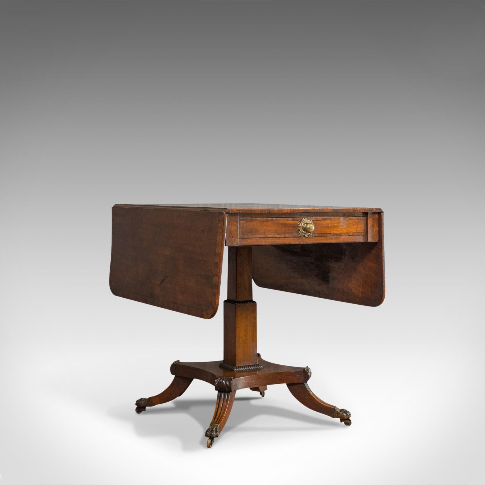 This is an antique Pembroke table. An English, mahogany drop-leaf occasional table dating to the Regency period, circa 1830.

Select mahogany displays fine grain interest and a desirable aged patina
Good consistent color throughout to its wax