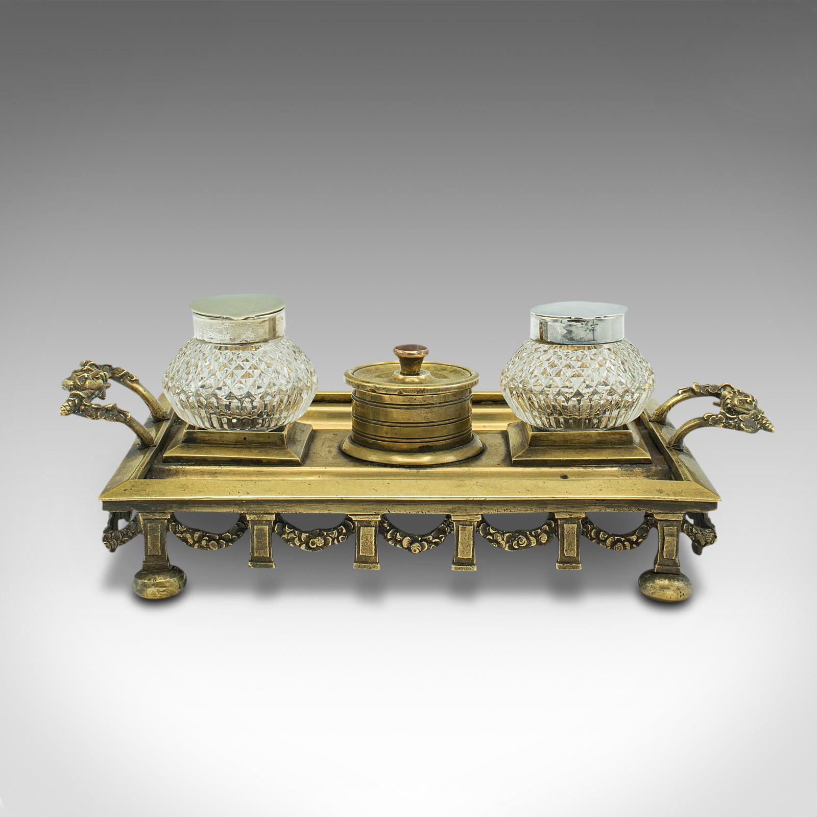 This is an antique pen tray. An English, brass and silver plated inkwell stand, dating to the Edwardian period and later, circa 1910.

Compact and neat, with appealing tonality
Displays a desirable aged patina and in good order
Brass presents