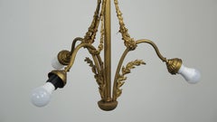 Antique pendant lamp with gold-coloured and ornate details and 3 fittings