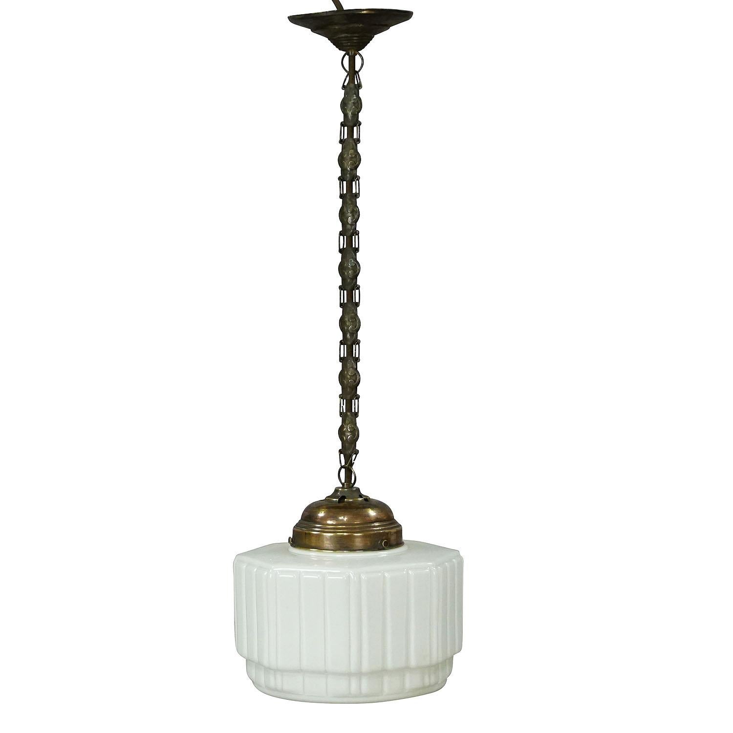 Antique pendant light with large white glass shade ca. 1920

An antique pendant lamp - a white opaline glass shade with ribbed decor and a very nice brass and metal suspension. Made in Germany, ca. 1920. Cabling is renewed, working order. With