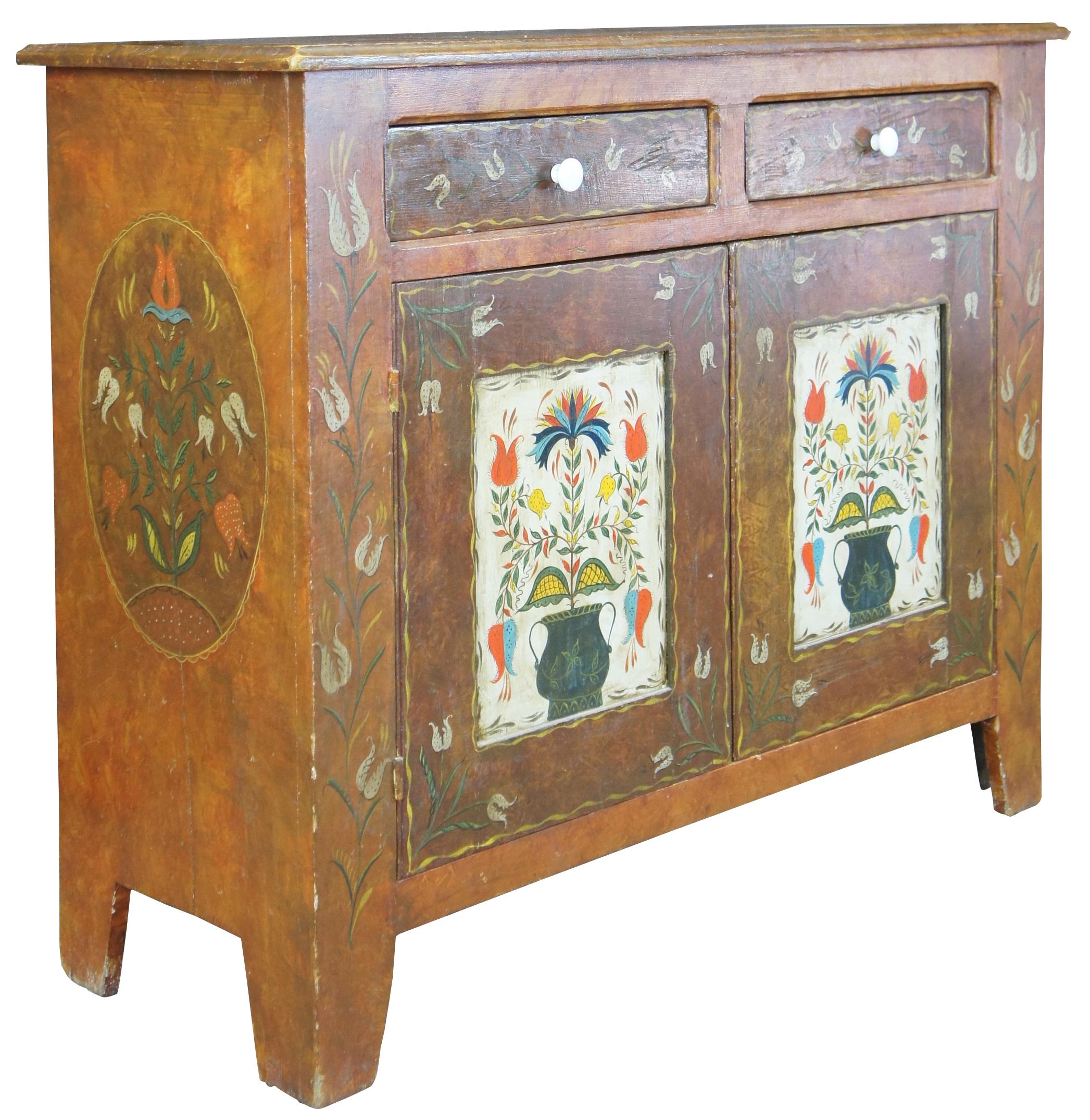 Late 19th Century Pennsylvannia Dutch Folk Art Cabinet. A rectangular form made from pine with a hand painted floral design over a burled base. Features 2 drawers over lower cabinet with one shelf and blue painted interior. Includes oval painted