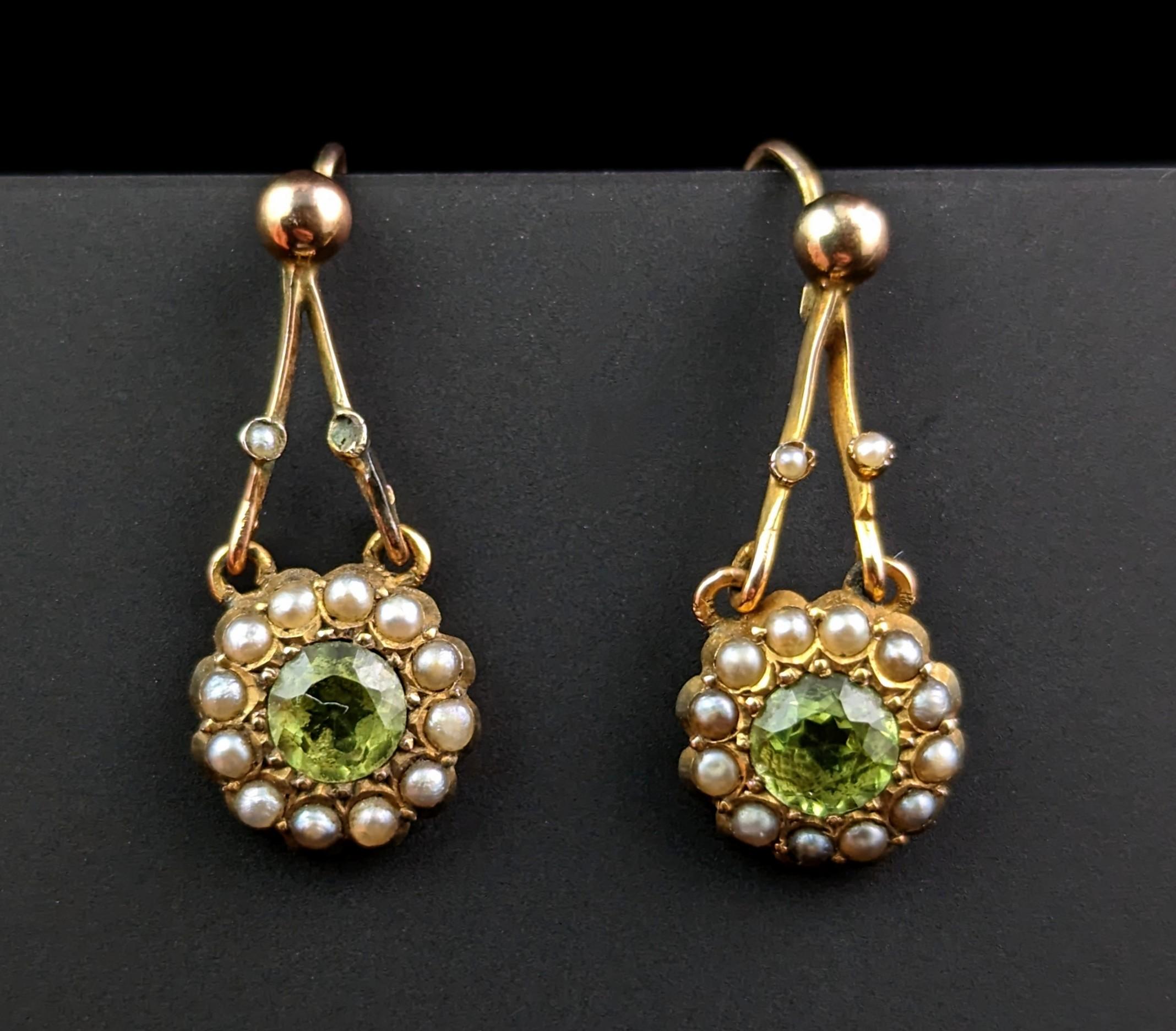 These antique Edwardian earrings are simply charming!

Crafted in rich 9ct yellow gold, they are a designed with an A frame drop from the top of the ear wire, the cluster hinged from the bottom.

The drop has two small seed pearls to each side
