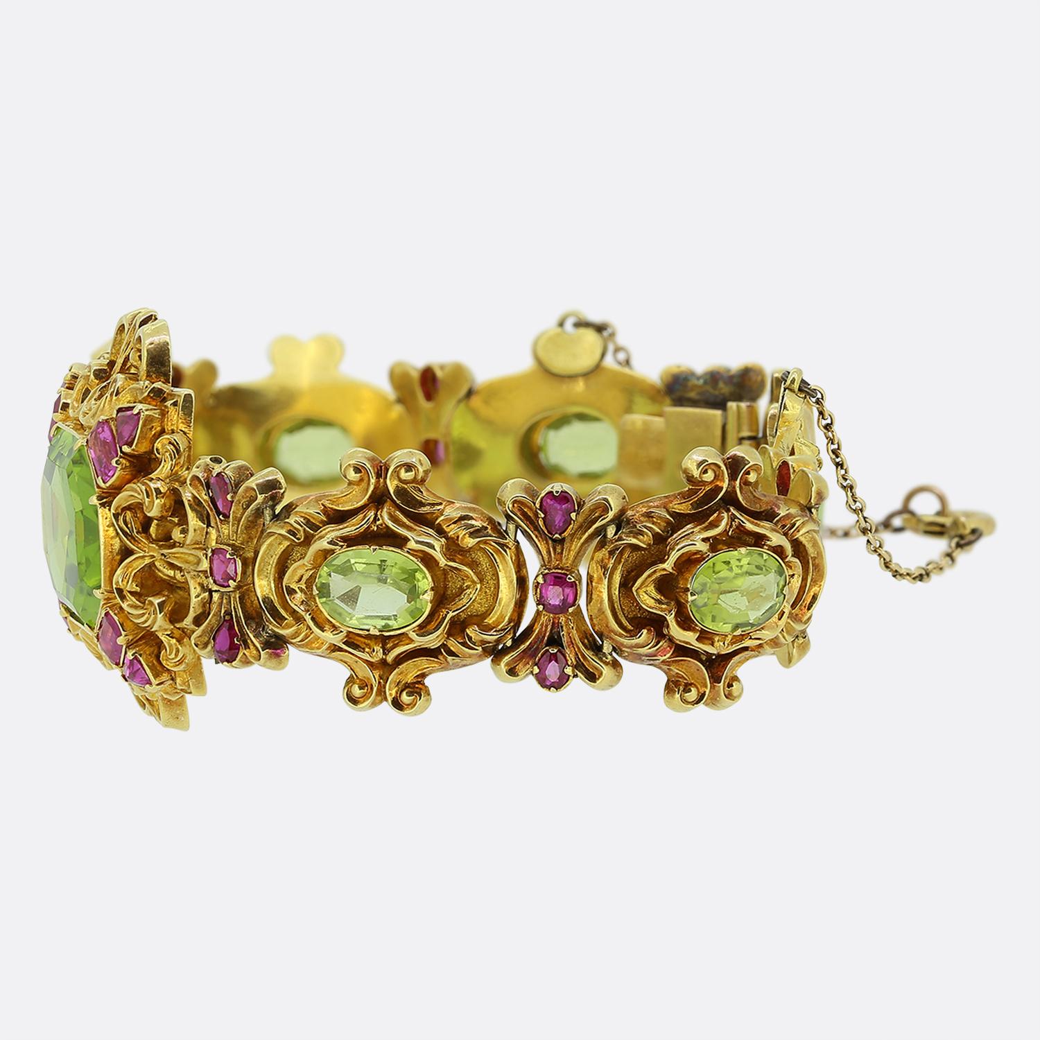Here we have a gorgeous bracelet dating back to the Victorian period. This distinctively bold and beautiful wrist piece has been artfully hand fabricated in a finely textured rich 15ct yellow gold with an impressive peridot possessing a strong green