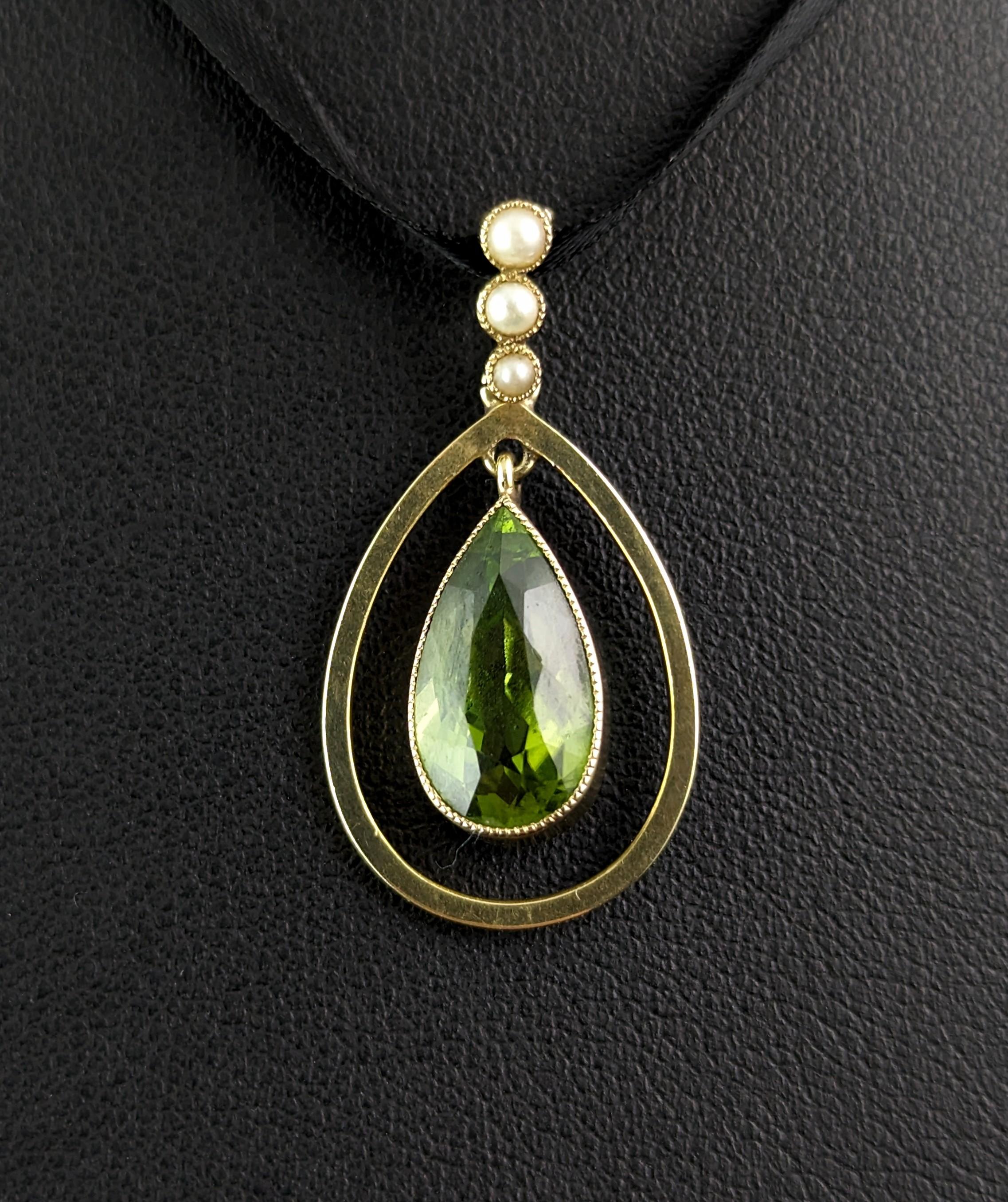 The Art Nouveau era really opened up the world to some beautiful delicate jewels, like this beautiful antique, Art Nouveau era Peridot and seed pearl pendant.

The pendant has a large pear cut Peridot suspended from the centre in a smooth gold bezel