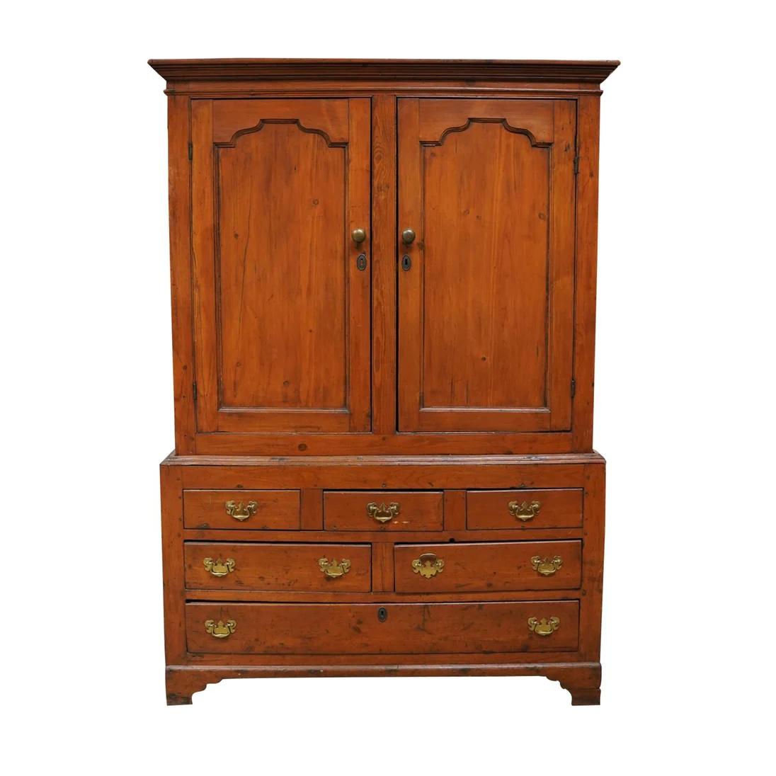 Late 18th C American Pine Linen Press constructed in an upper and lower section. Two upper paneled doors open to a compartment with two shelves. Lower section is comprised of three drawers over two drawers over one drawer. Retains early finish with