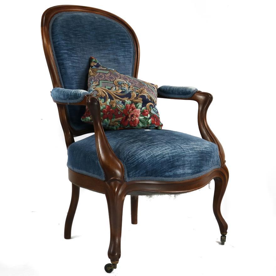 American Victorian upholstered armchair, circa 1860, executed in walnut upholstered in a vintage midnight blue velvet upholstery fabric.