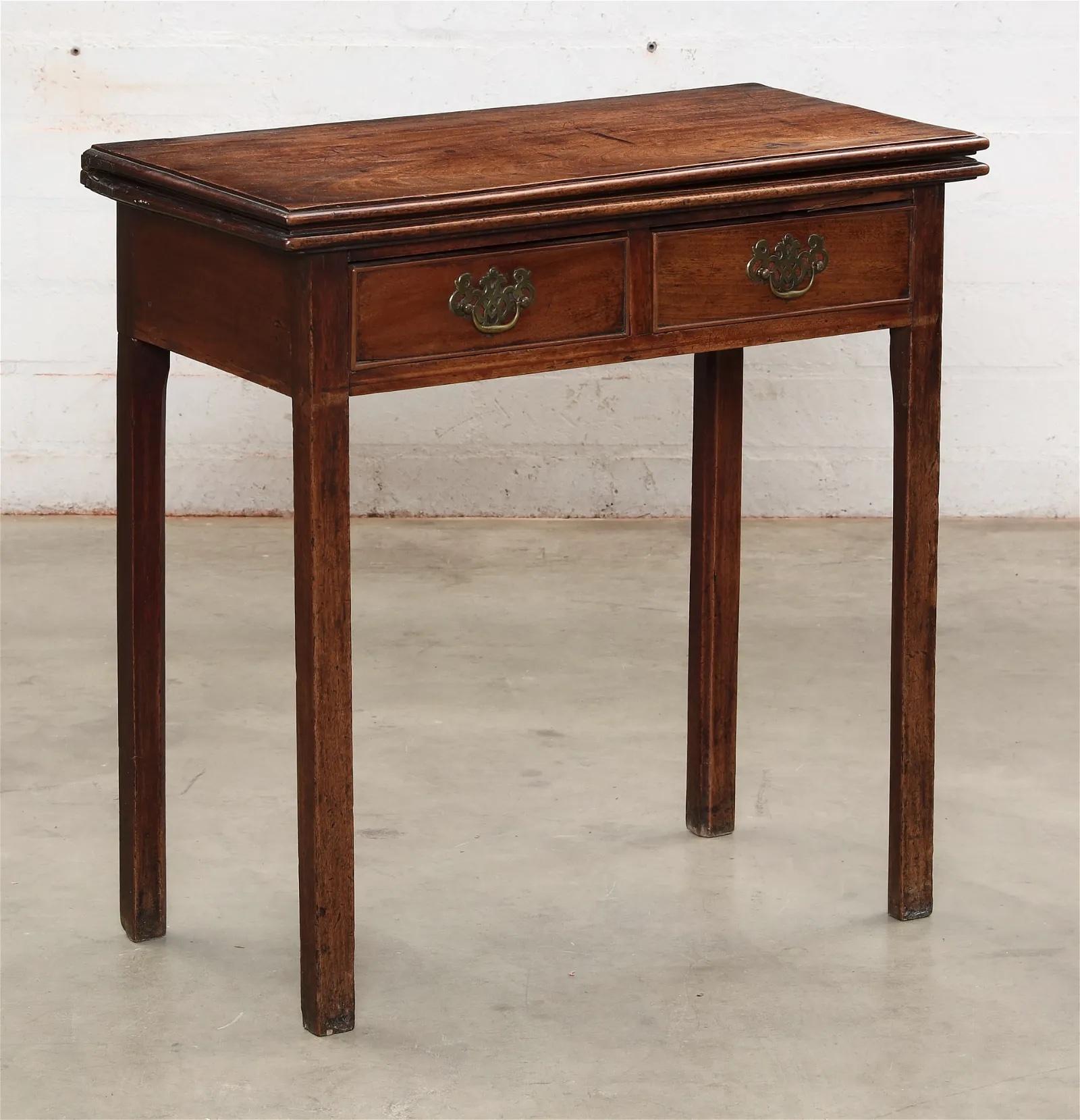 A George III mahogany fold over card table - late 18th century. Left rear leg acts as a gateleg to swing to the rear to support fold over table top leaf. Closed Dimensions: height 28
