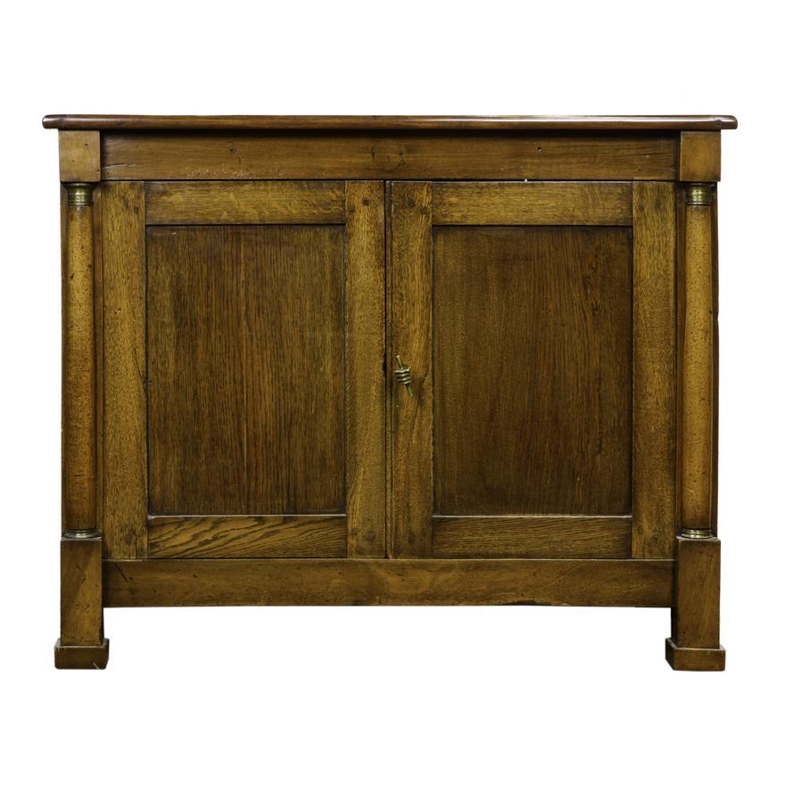 Circa 1810 French Empire (Napoleon)  Empire Two Door Cabinet Comprised of Mixed Woods (Walnut, Elm & Oak), having a rectangular top above a pair of paneled mahogany doors with a cast brass pull in the form of a clasped hand, flanked with tapered