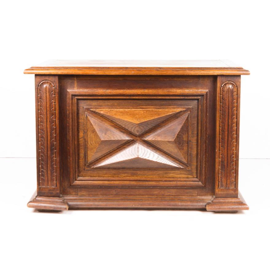 Late 18th Century French Provincial Carved Walnut Coffer Bench, having a hinged rectangular top, above a carved paneled walnut front, and rising on a molded base. Hardwood construction with hand cut doweled joinery throughout. Retains an old finish.