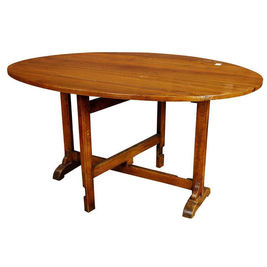 Mid 18th Century Antique Period French Provincial walnut drop leaf wine table circa 1750, having an oval top, the trestle base with swing out legs, and rising on shoe feet, 
