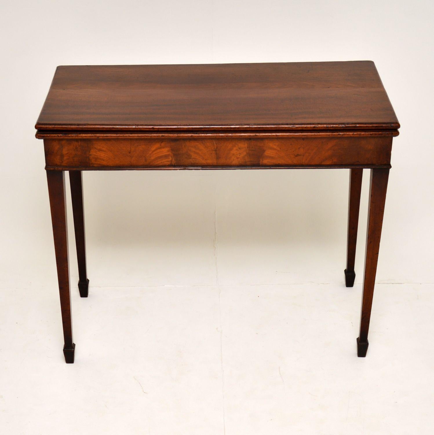 Antique George III period mahogany card table in very good original condition and dating to circa 1790s period.

The back two legs open out to support the playing surface, which has just had a new baize cloth put on. There is a bit of evidence of