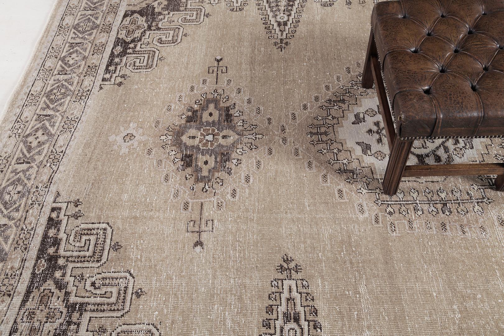 A breathtaking antique Persian Afshar rug that features a stunning muted neutral colour palette. Elegantly composed and highlighting a captivating all-over symbollical design, this sophisticatd rug tells a wonderful story through its elements. This