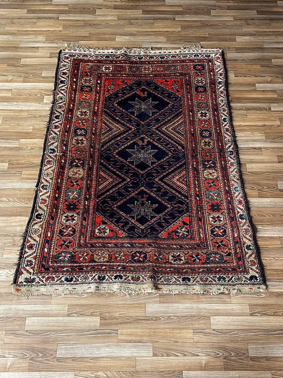 Condition: Original Vintage Condition

Materials: Hand-Knotted Wool

This vintage Persian Afshar tribal rug, handwoven in Iran, showcases a striking geometric medallion design with intricate floral and star motifs. Crafted from hand-knotted wool, it