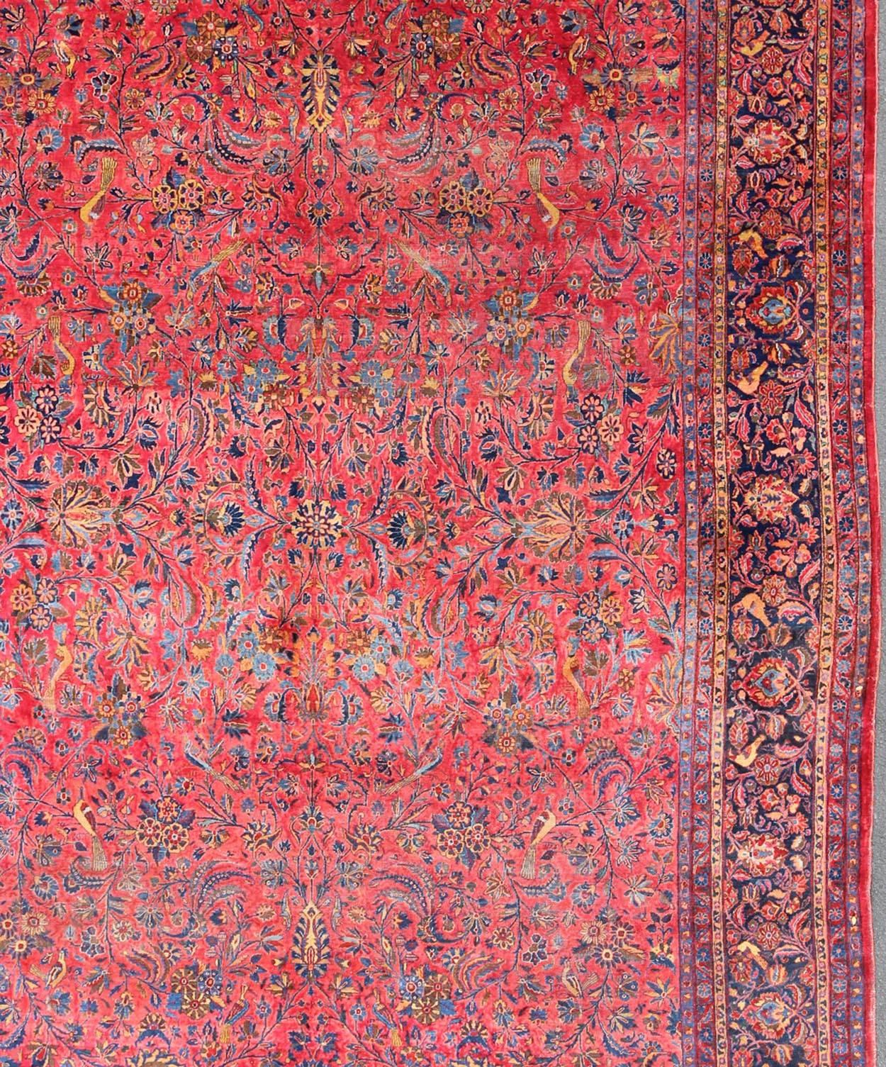 Hand-Woven Antique Persian Kashan Rug With a All-Over Design On A Red Field and Blue Border For Sale
