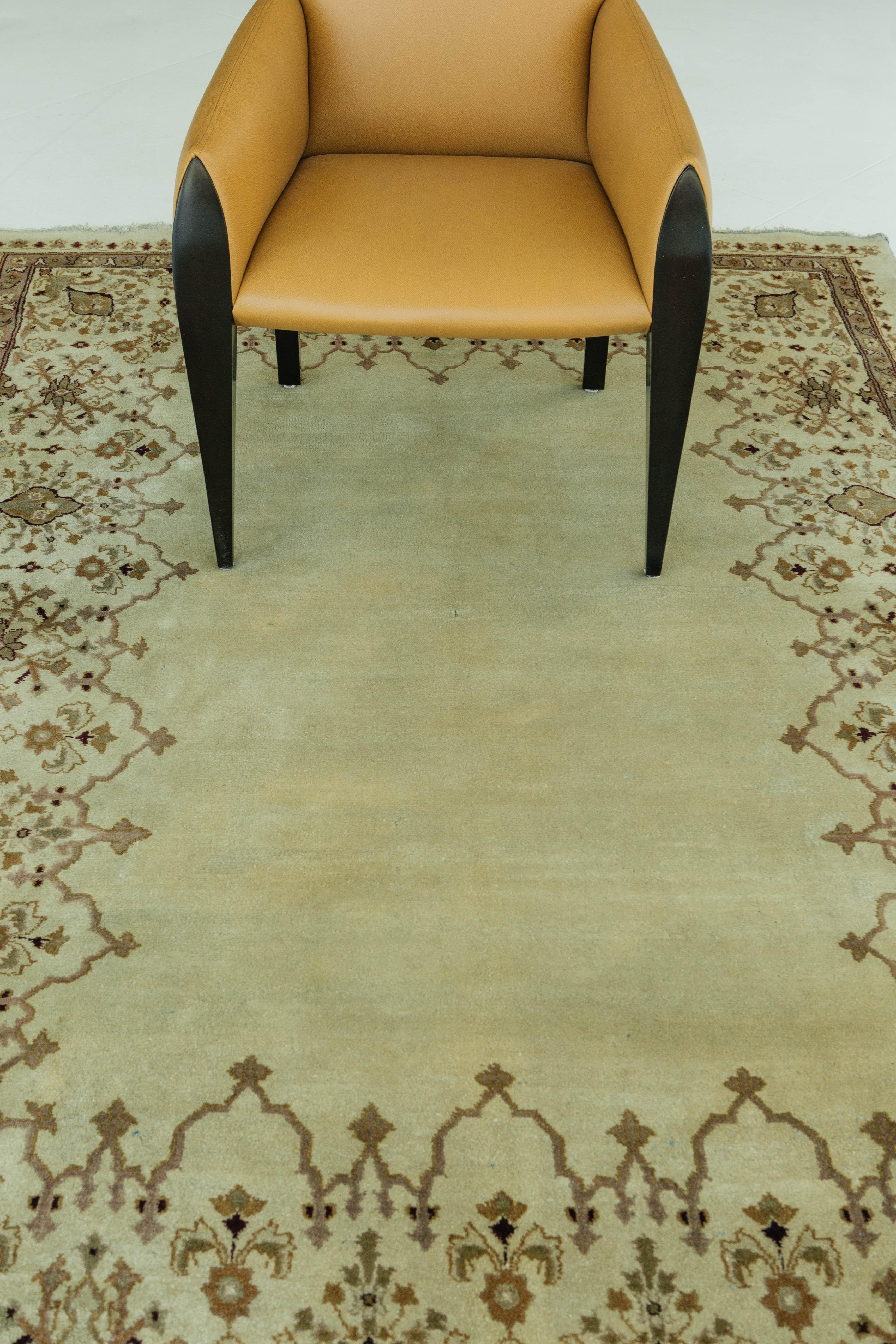 An antique Persian Amritsar rug with an open field. This rug features an open design, with a large clear beige center. The outer sides of the rug have a Herati pattern that draws the viewers eyes back to the center of the rug. The patterns of this